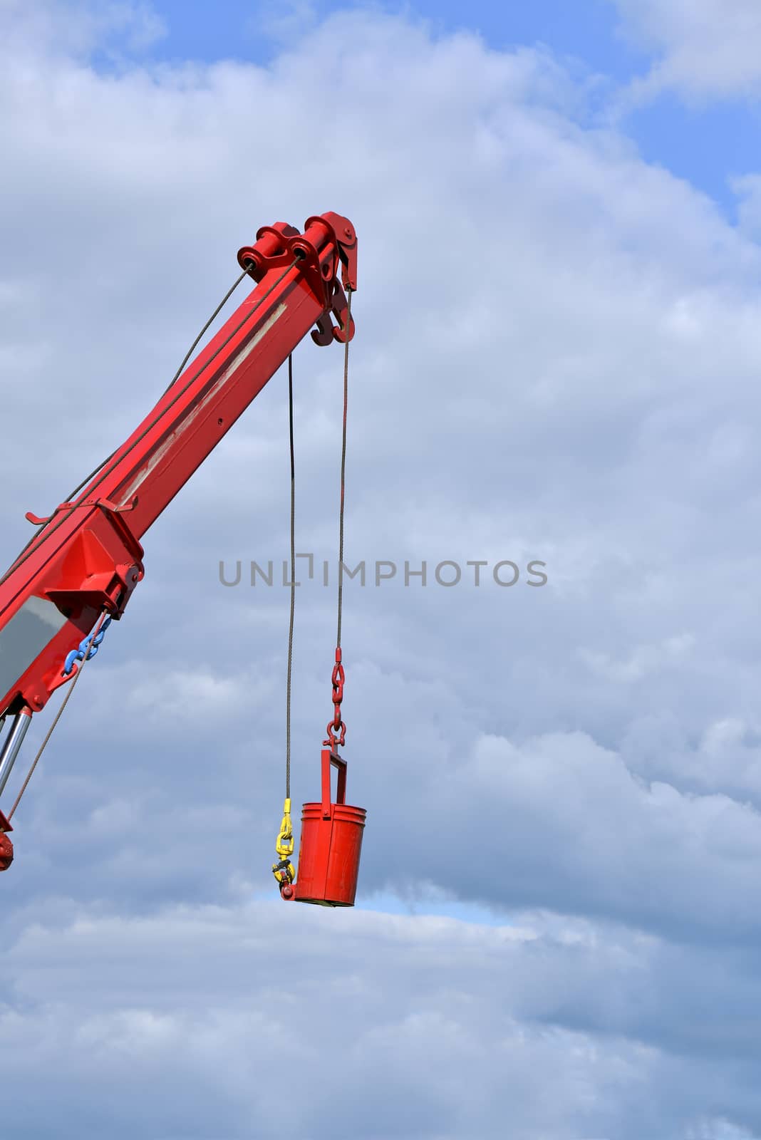 Truck crane lifted a tank in a sunny day