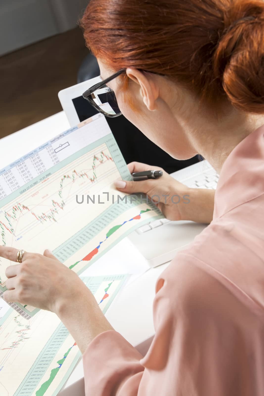 Young Businesswoman Looking at Computer Seriously by juniart