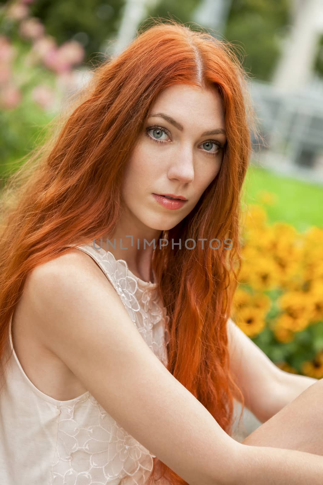 Close up Gorgeous Young Woman with Long Blond Hair, Posing at the Garden While Looking at Camera