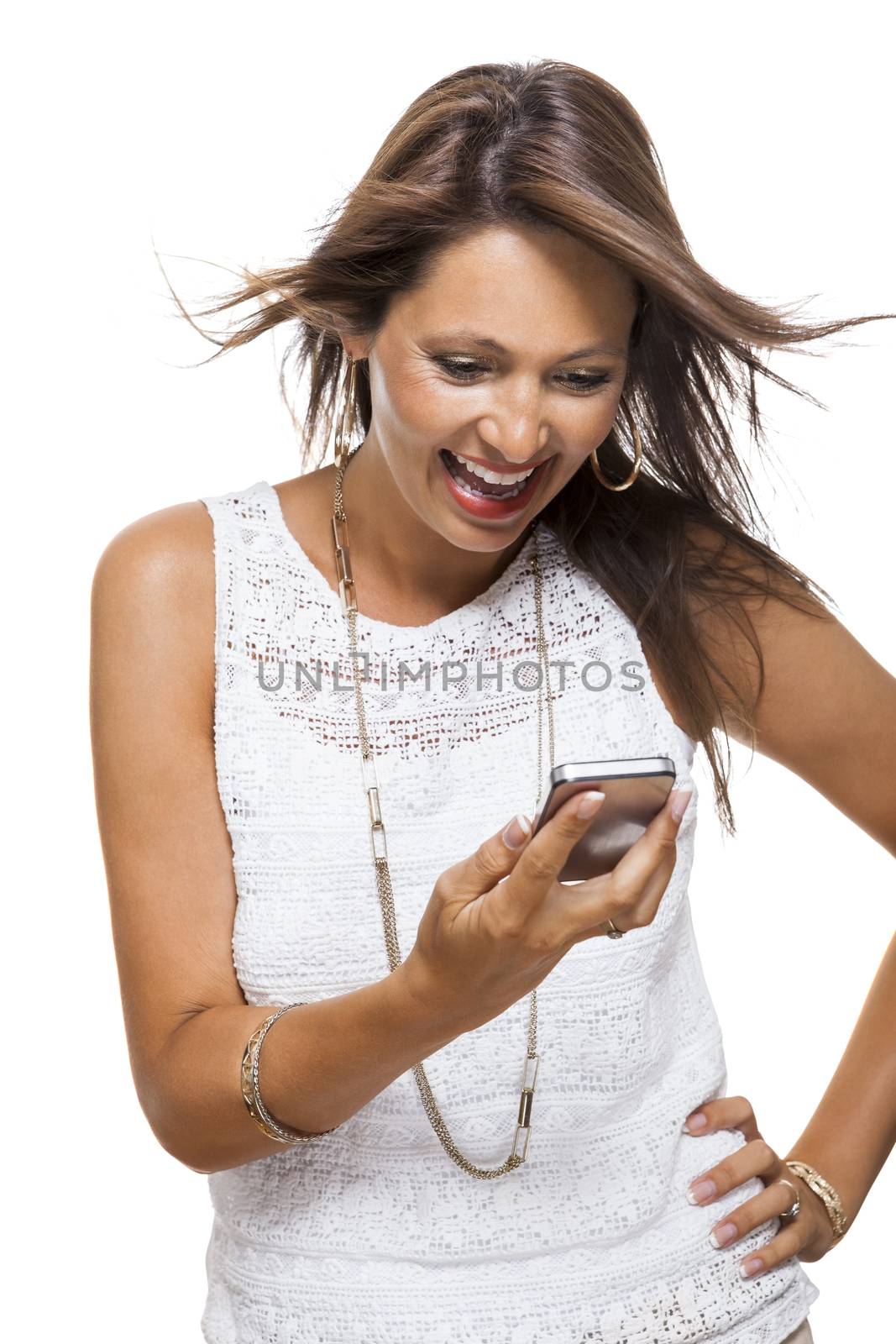 Vivacious attractive woman reacting to a text message on her mobile phone flicking her hair in the air and staring at the phone with her mouth open, on white with copyspace