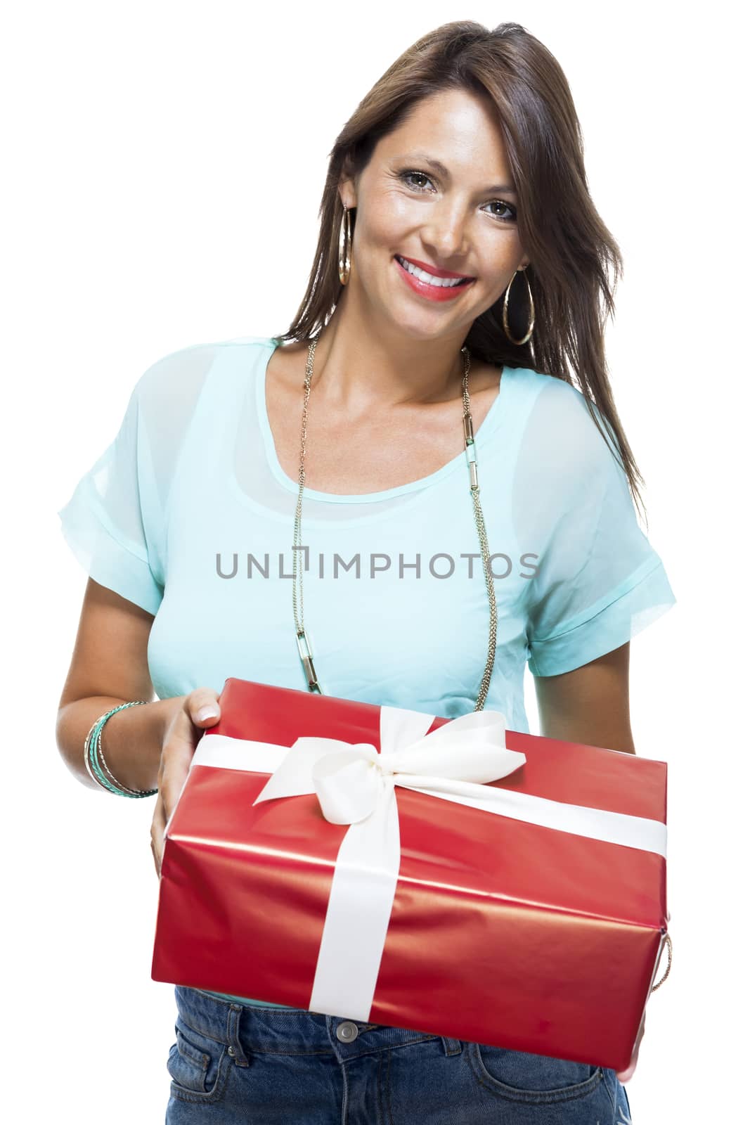 Close up Portrait of Happy Young Woman in Casual Clothing Holding a Red Big Gift Box with White Ribbon While Looking at the Camera. Isolated on White Background.