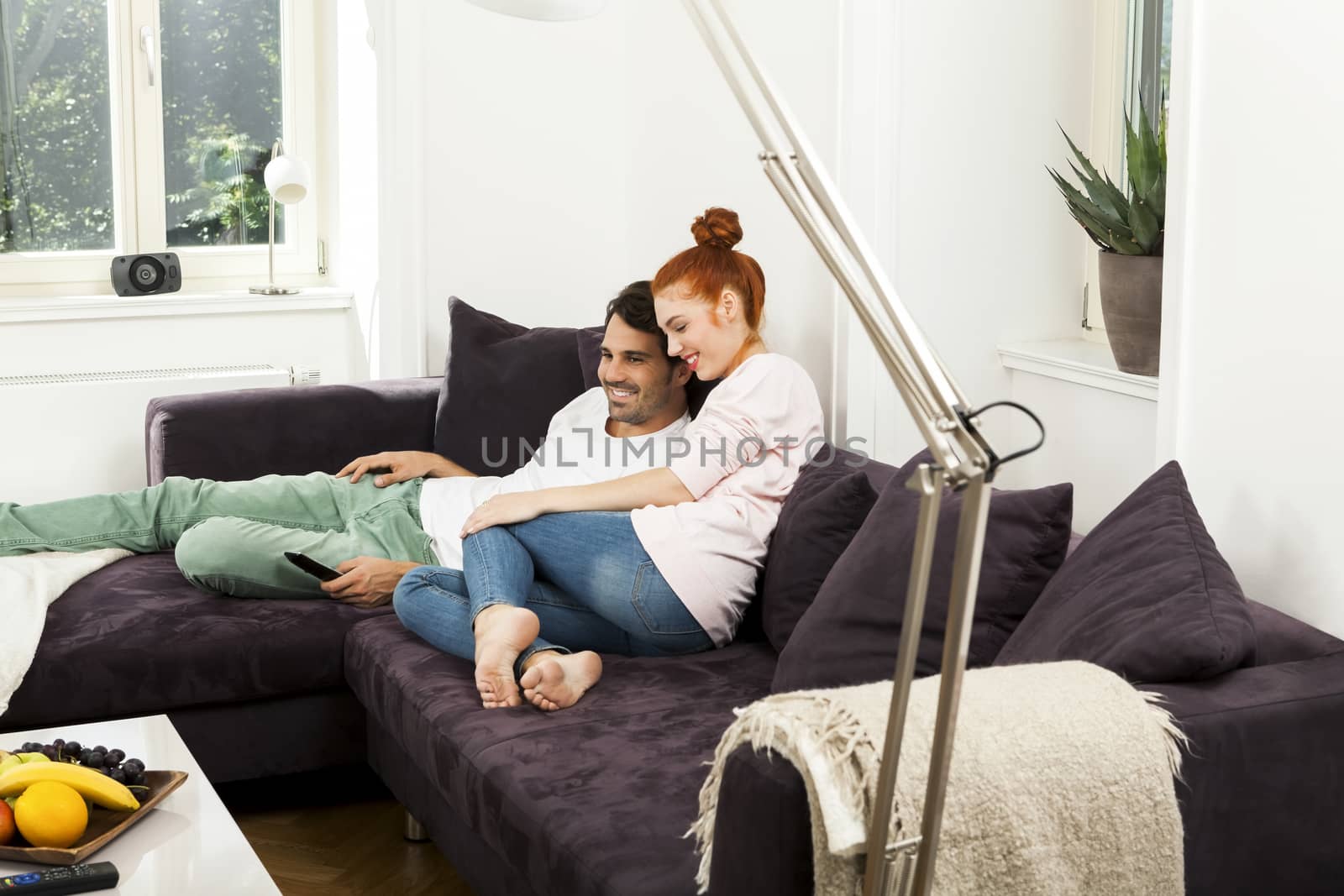 Happy Young Sweet Couple Sitting at the Couch by juniart