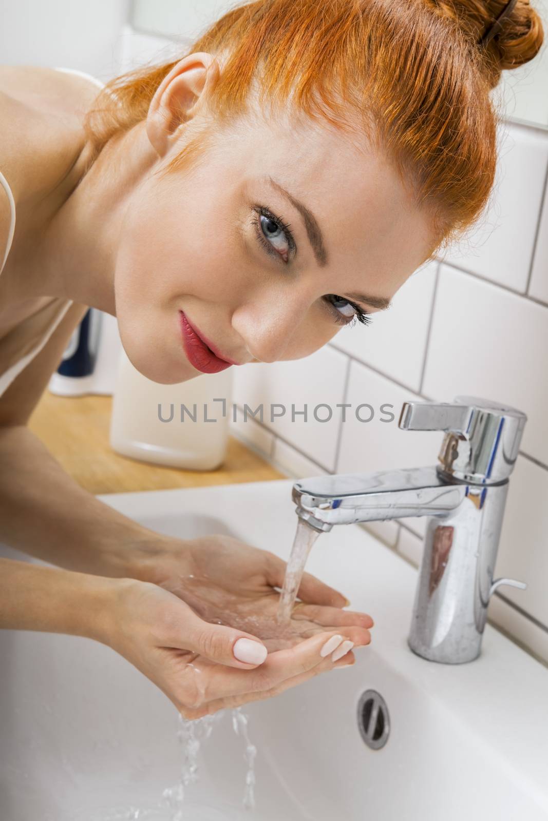 Woman Washing her Face While Looking at the Camera by juniart