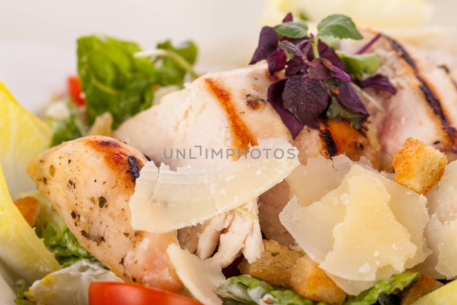 tasty fresh caesar salad with grilled chicken parmesan and croutons