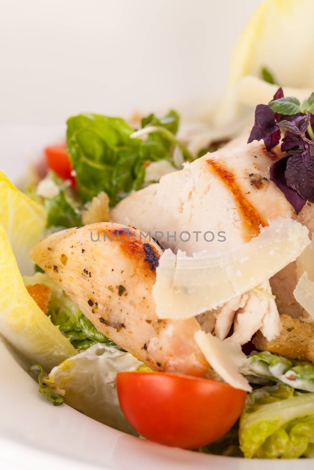 tasty fresh caesar salad with grilled chicken parmesan and croutons