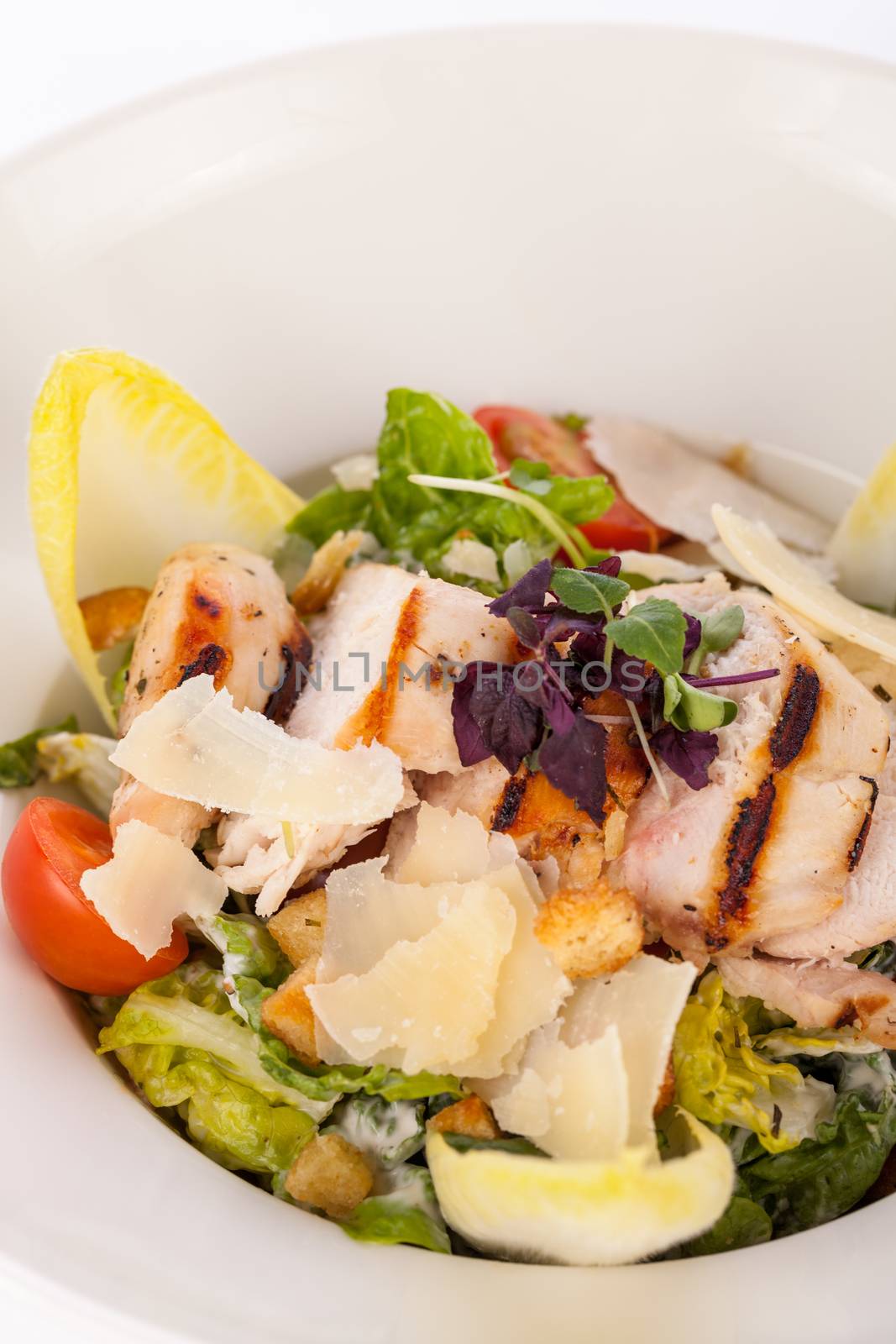 tasty fresh caesar salad with grilled chicken parmesan and croutons