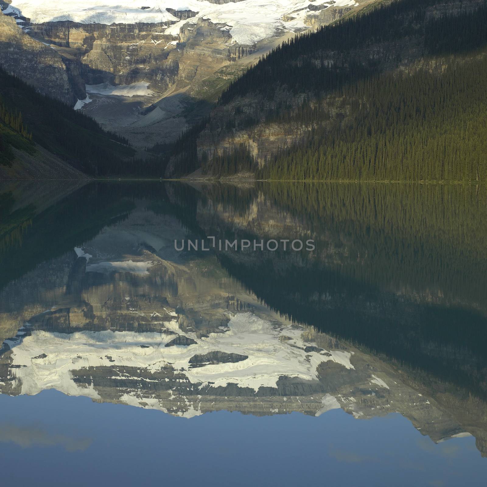 Mountains with snow reflected in a calm lake