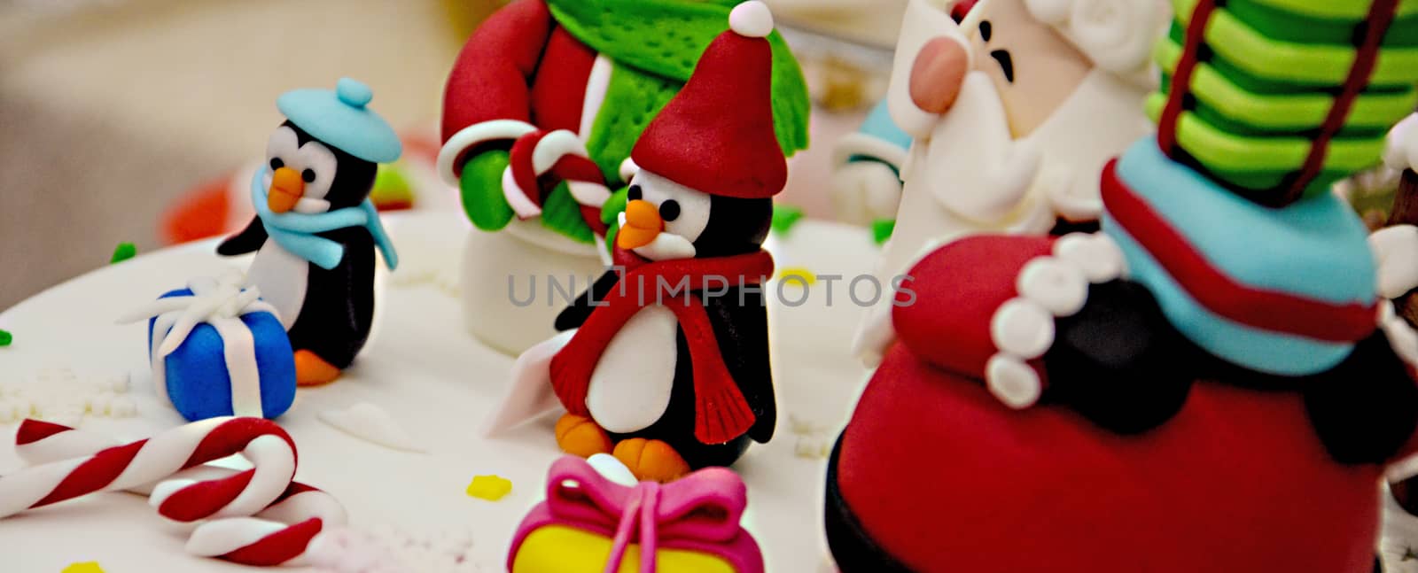 New year and Xmas cake with figurines of Santa, Snow man and penguin