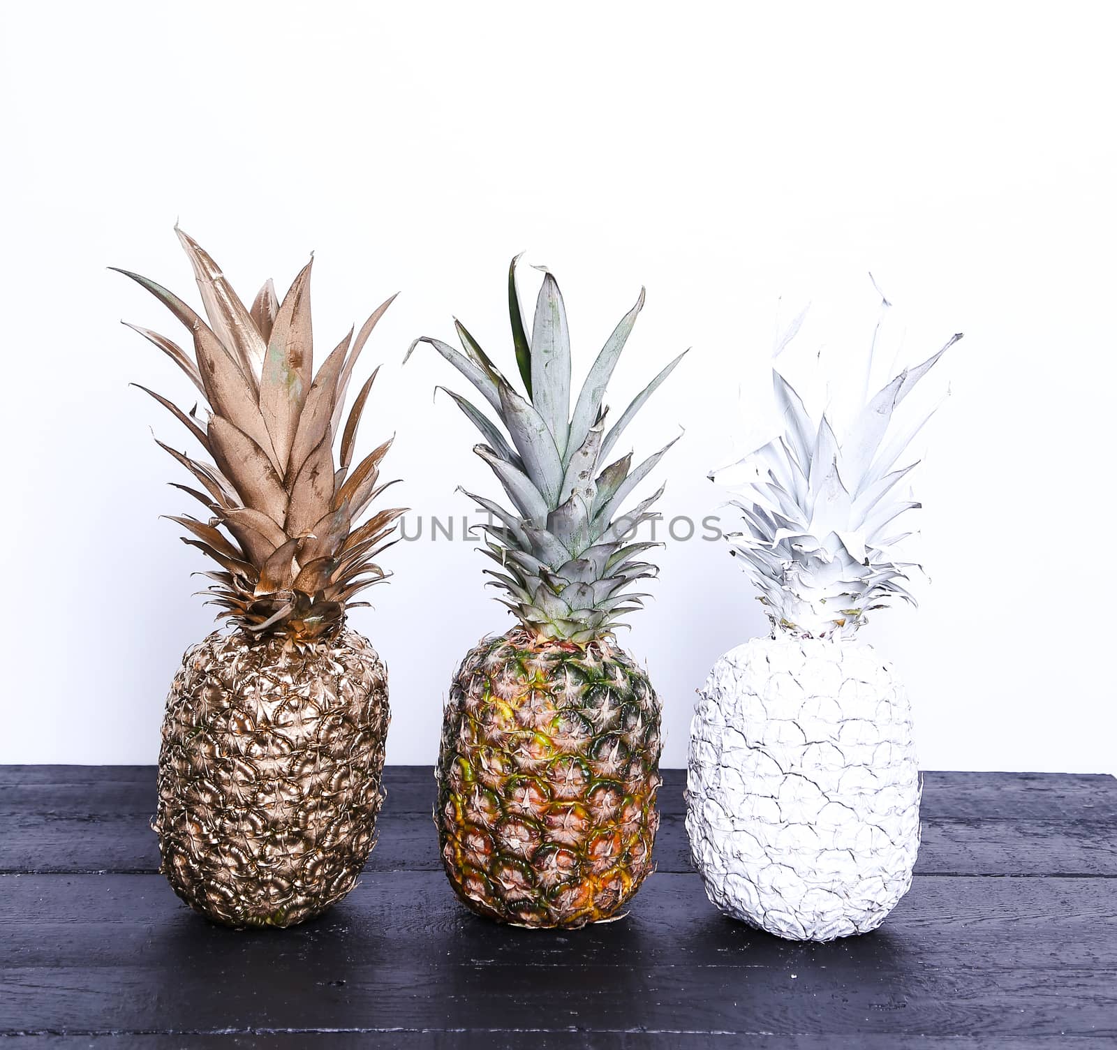 Fancy, white pineapple on the wooden table