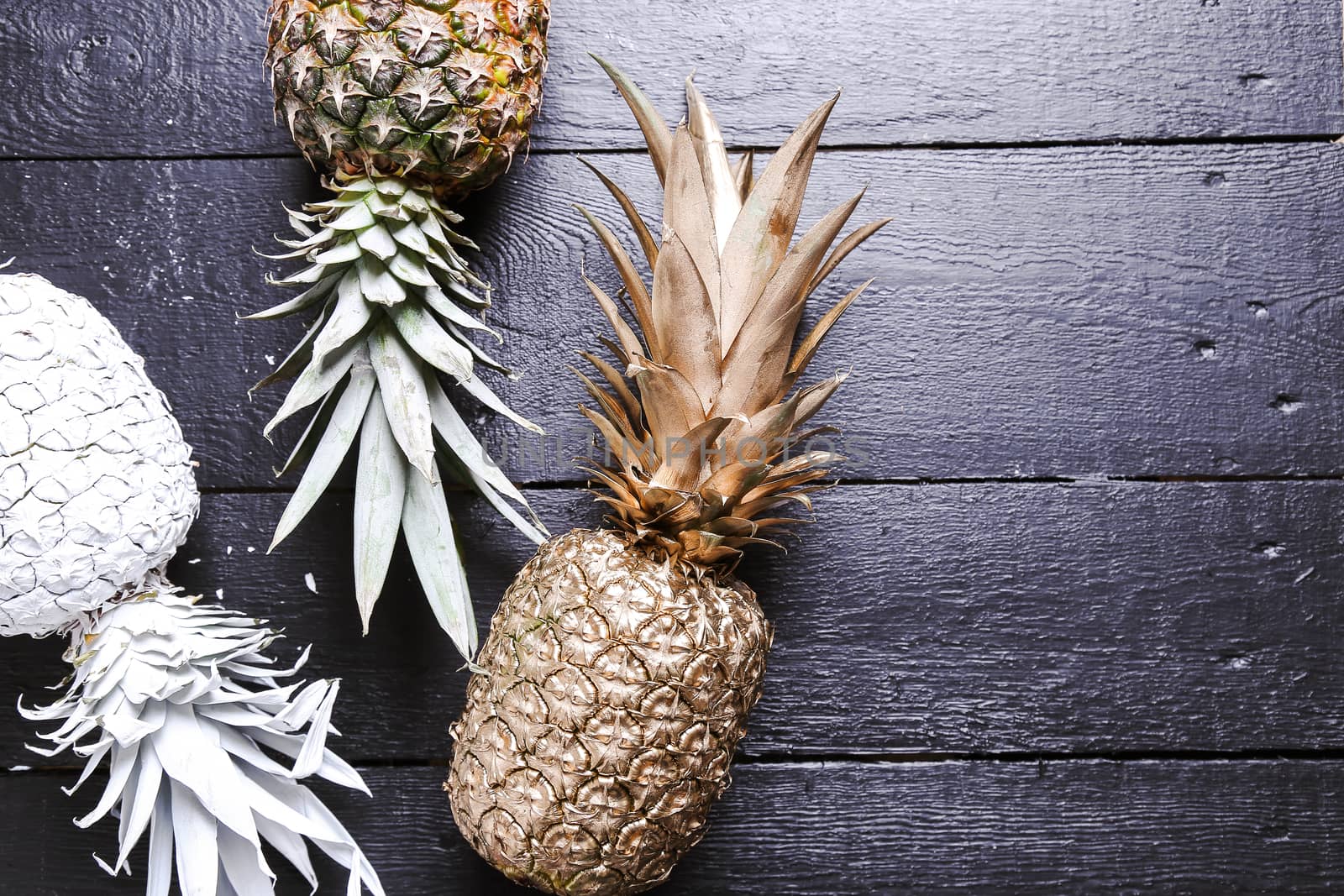 Fancy, white pineapple on the wooden table