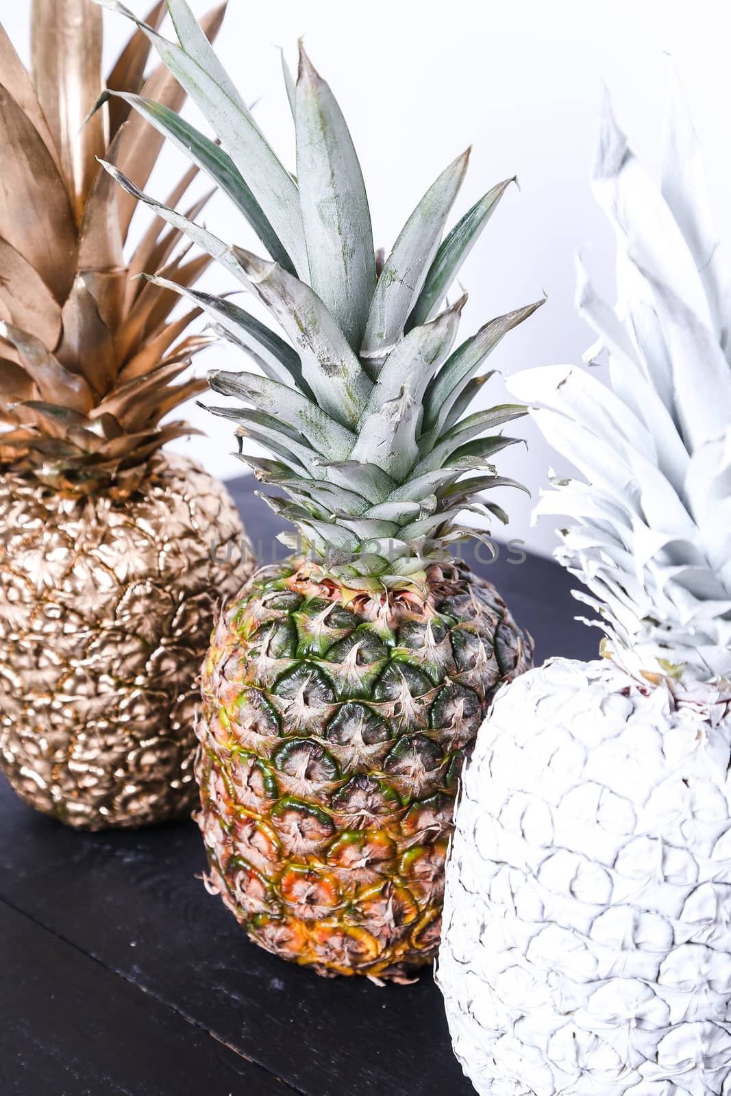 Fancy, white pineapple on the wooden table