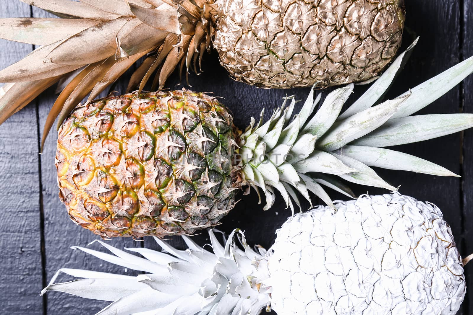 Fancy, white pineapple on the wooden table