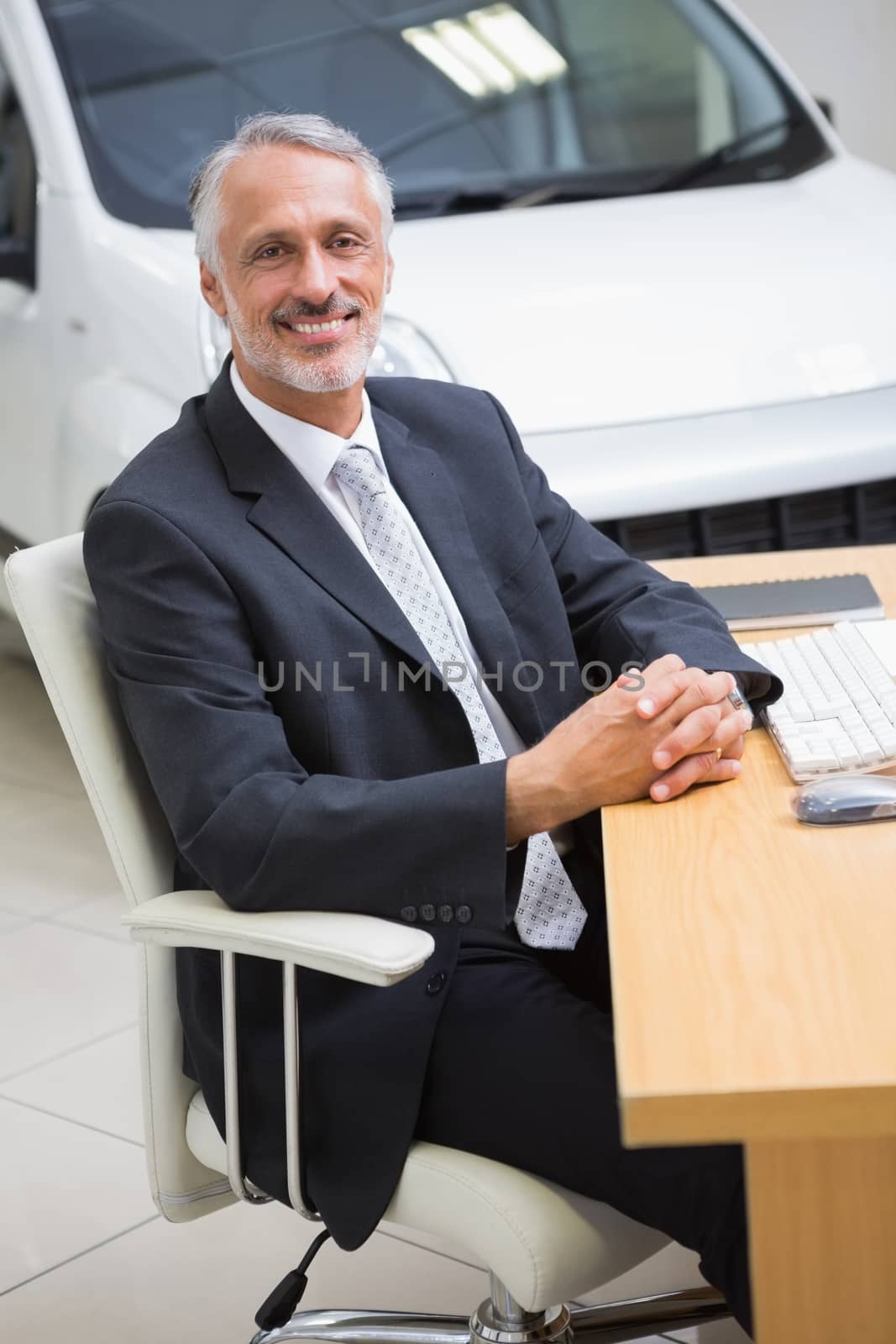 Happy businessman working at his desk by Wavebreakmedia