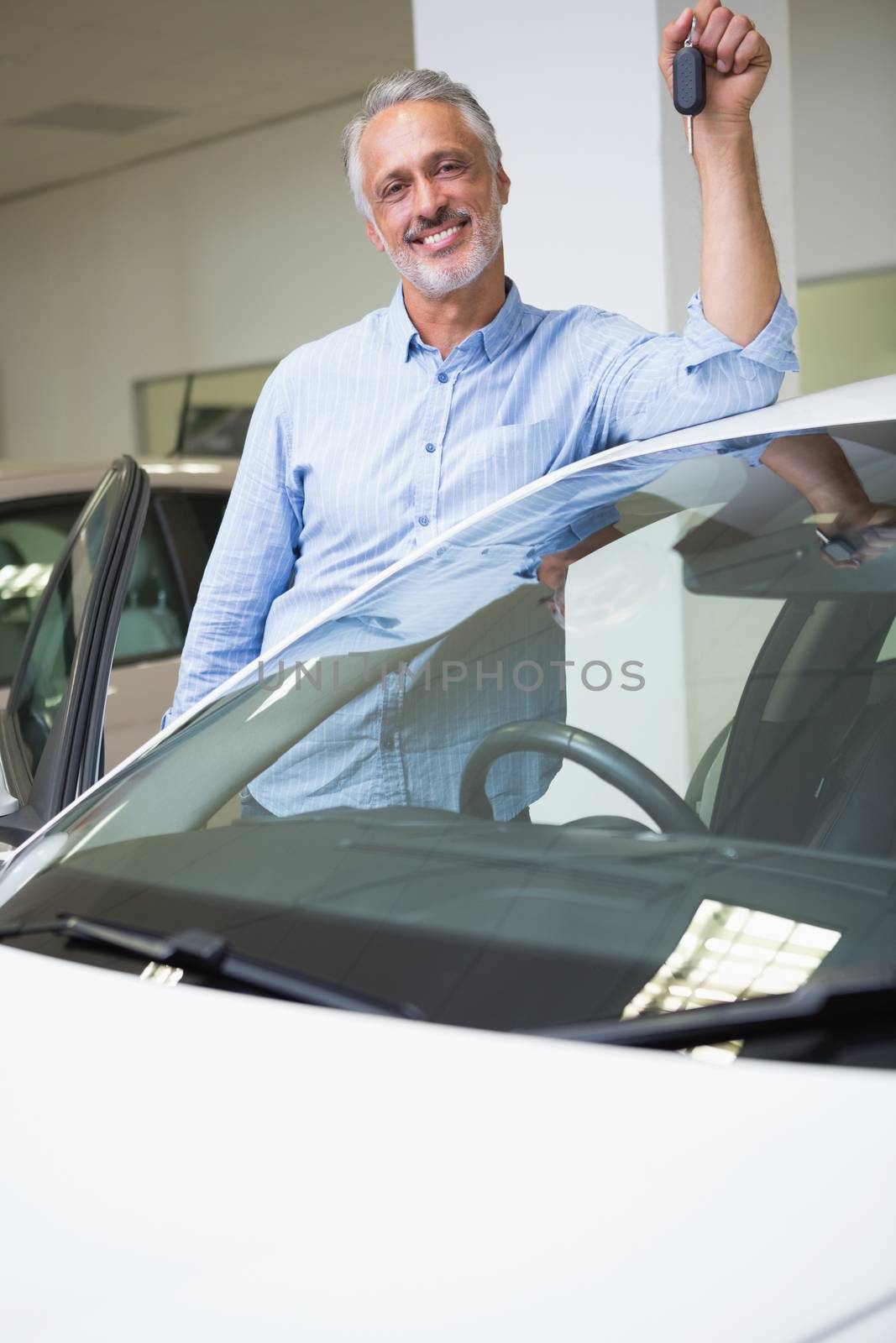 Smiling man holding car key by Wavebreakmedia