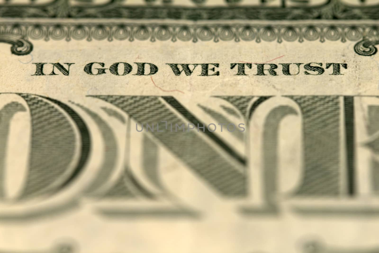 Photo of banknote one dollar with sign "In God we trust". 