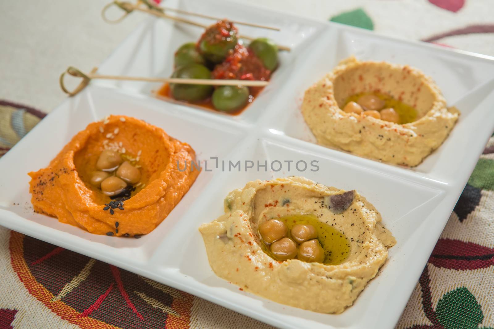 Delicious and healthy hummus set in white pate.