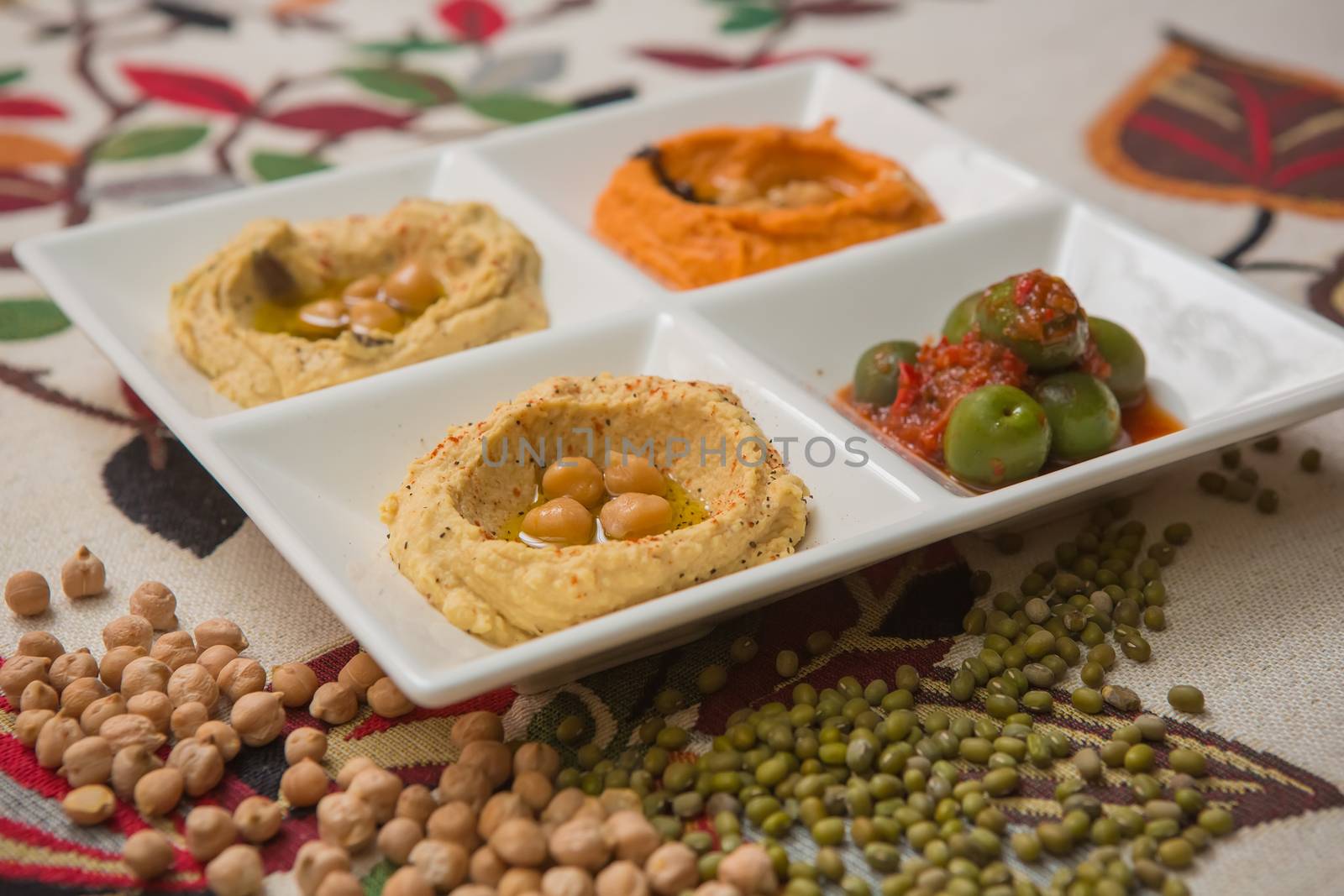 Delicious and healthy hummus set in white pate.