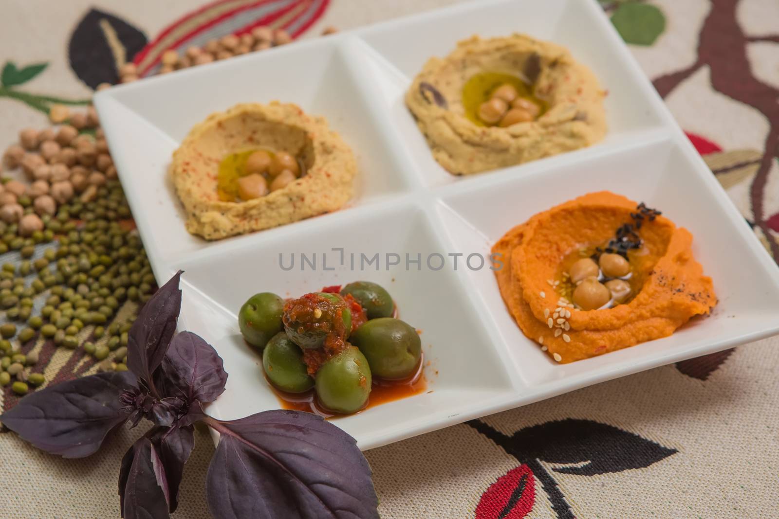 Delicious and healthy hummus set in white pate.