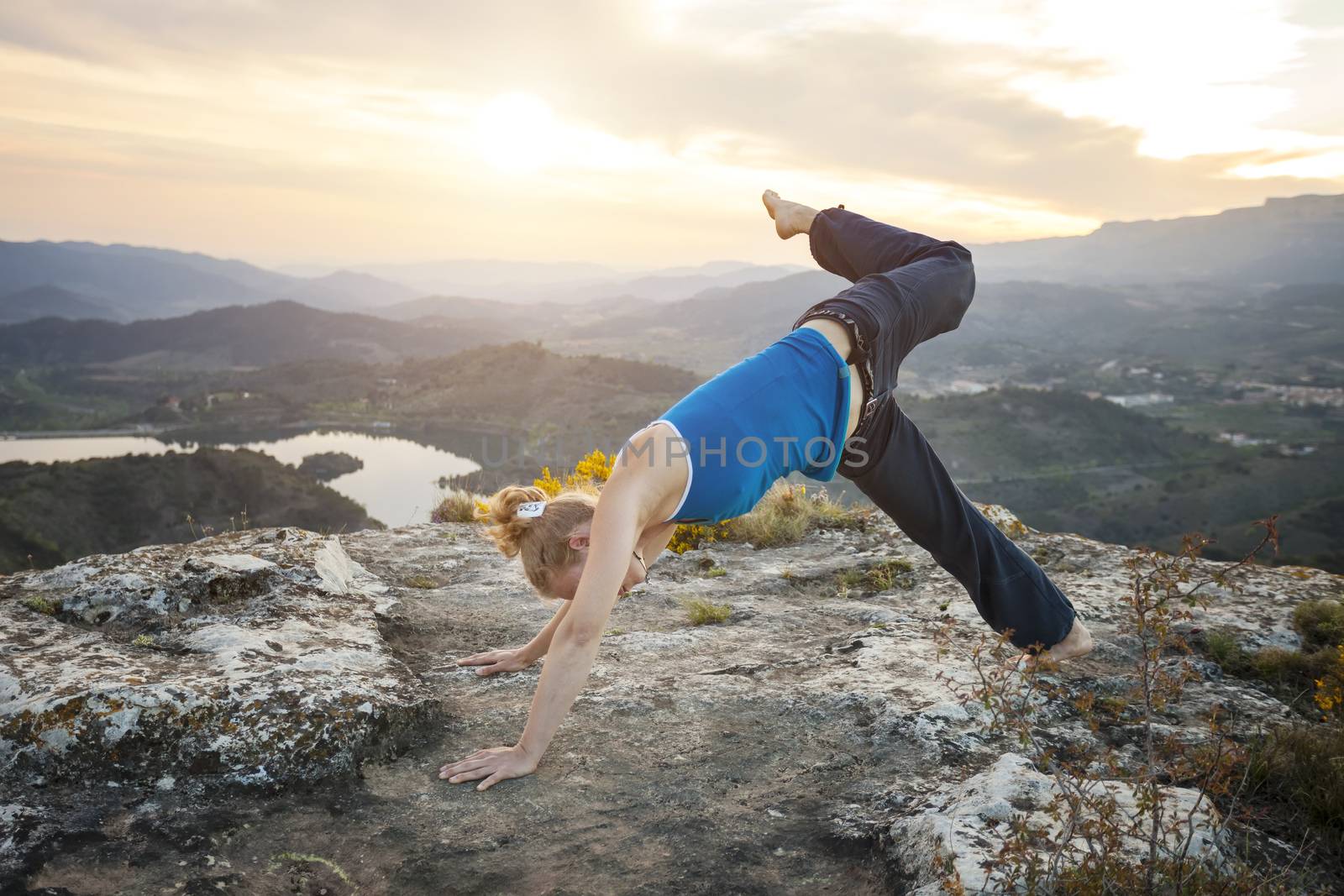 Caucasian woman performing downward dog yoga pose by photobac