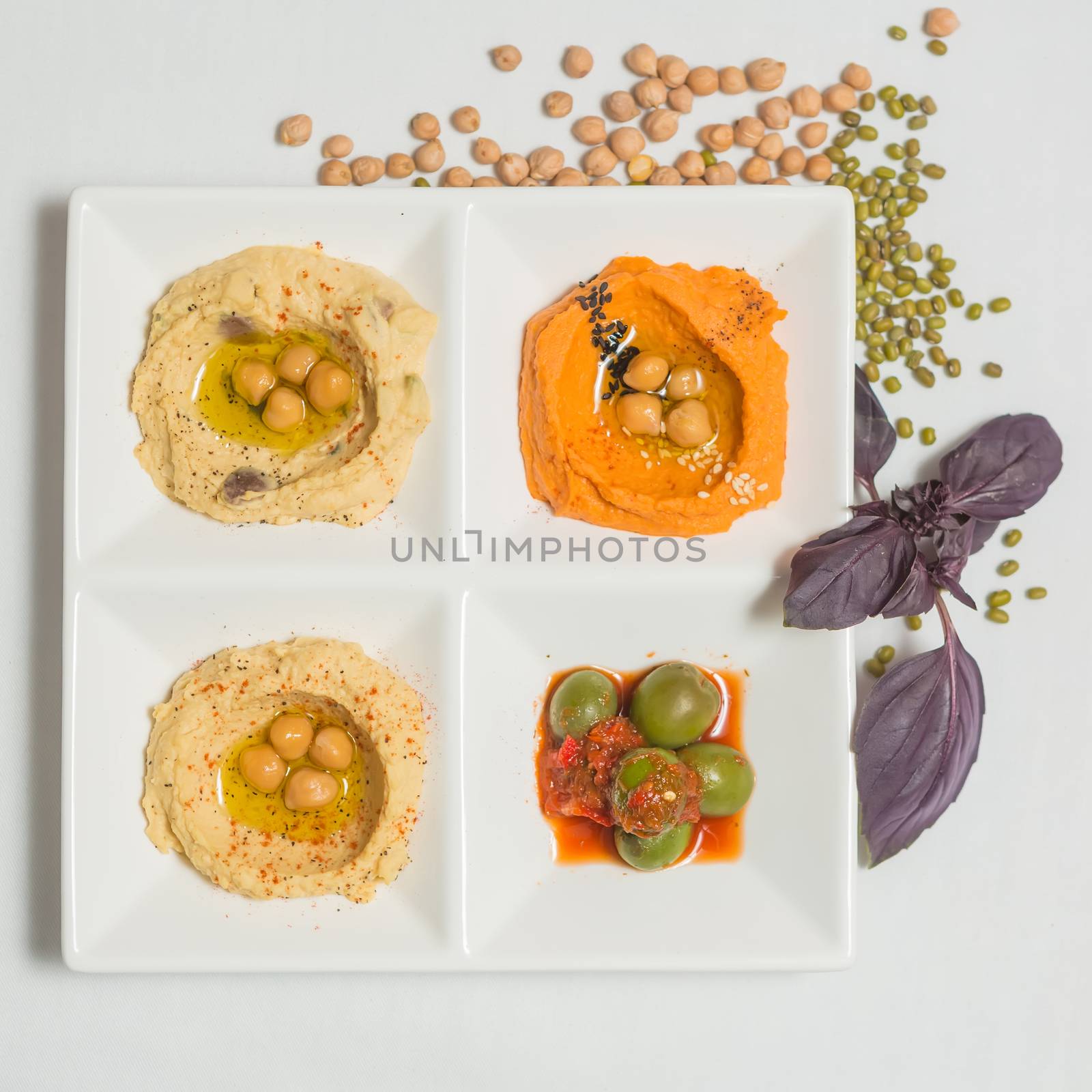 Delicious and healthy hummus set in white pate.