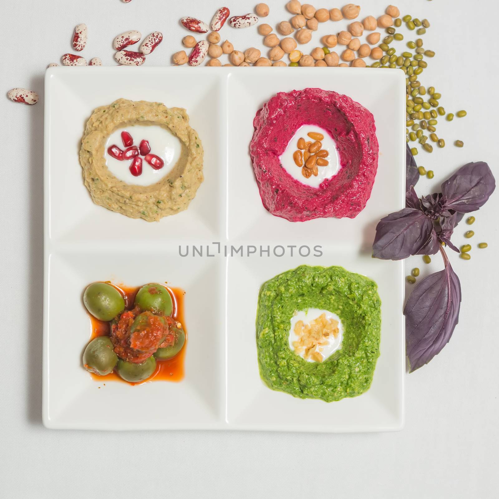 Delicious and healthy hummus set in white pate.