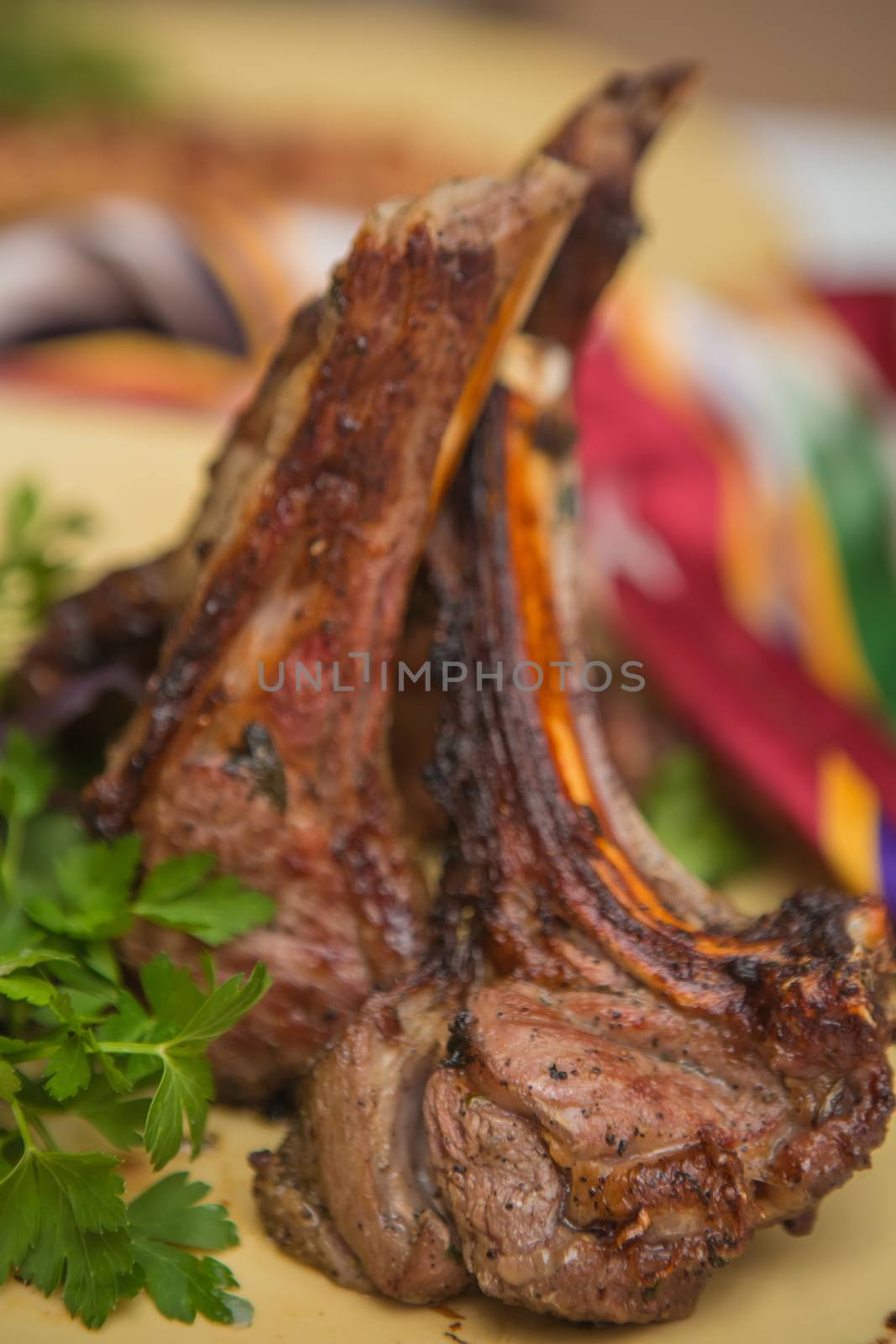 Grilled organic veal fillet on yellow plate with salad