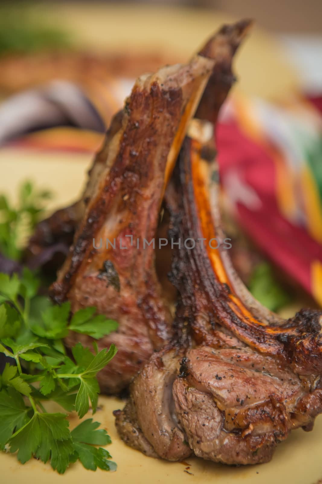 Grilled organic veal fillet on yellow plate with salad