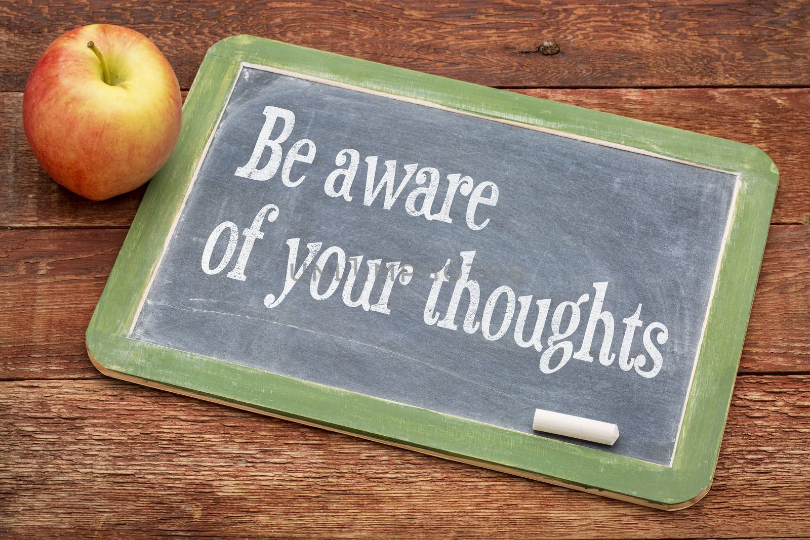 Be aware of your thoughts - inspirational  words on a slate blackboard against red barn wood