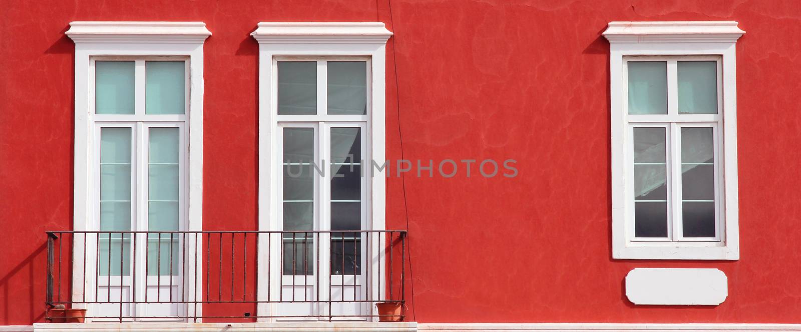 Spain. Canary Islands. Gran Canaria island. Las Palmas de Gran Canaria. Detail of ochre facade with three windows
