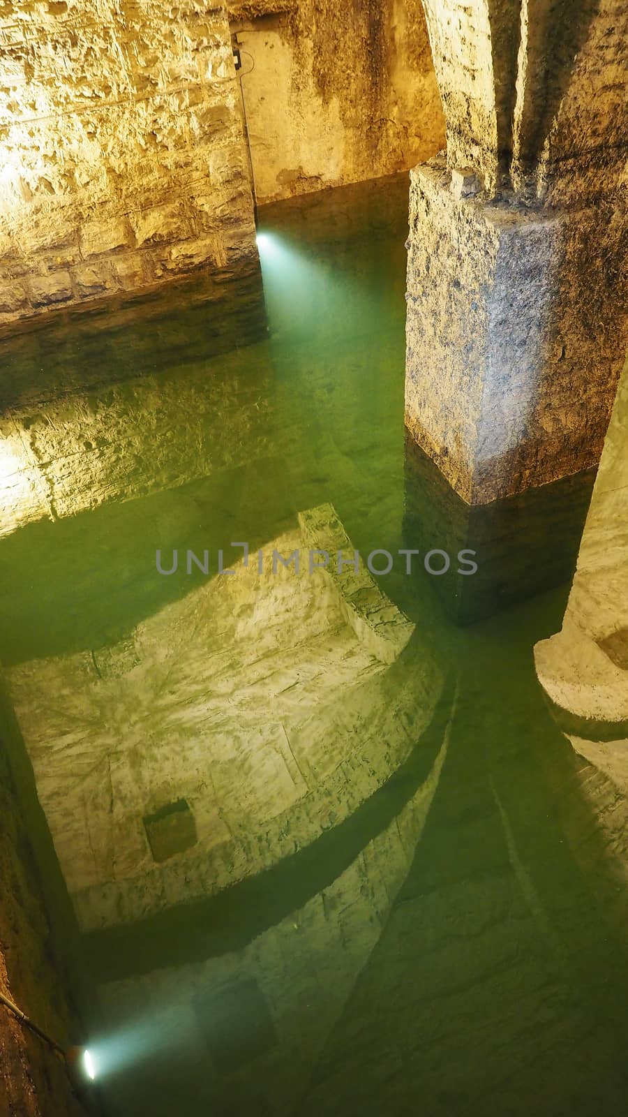 Old historical underground water well in medieval environment    