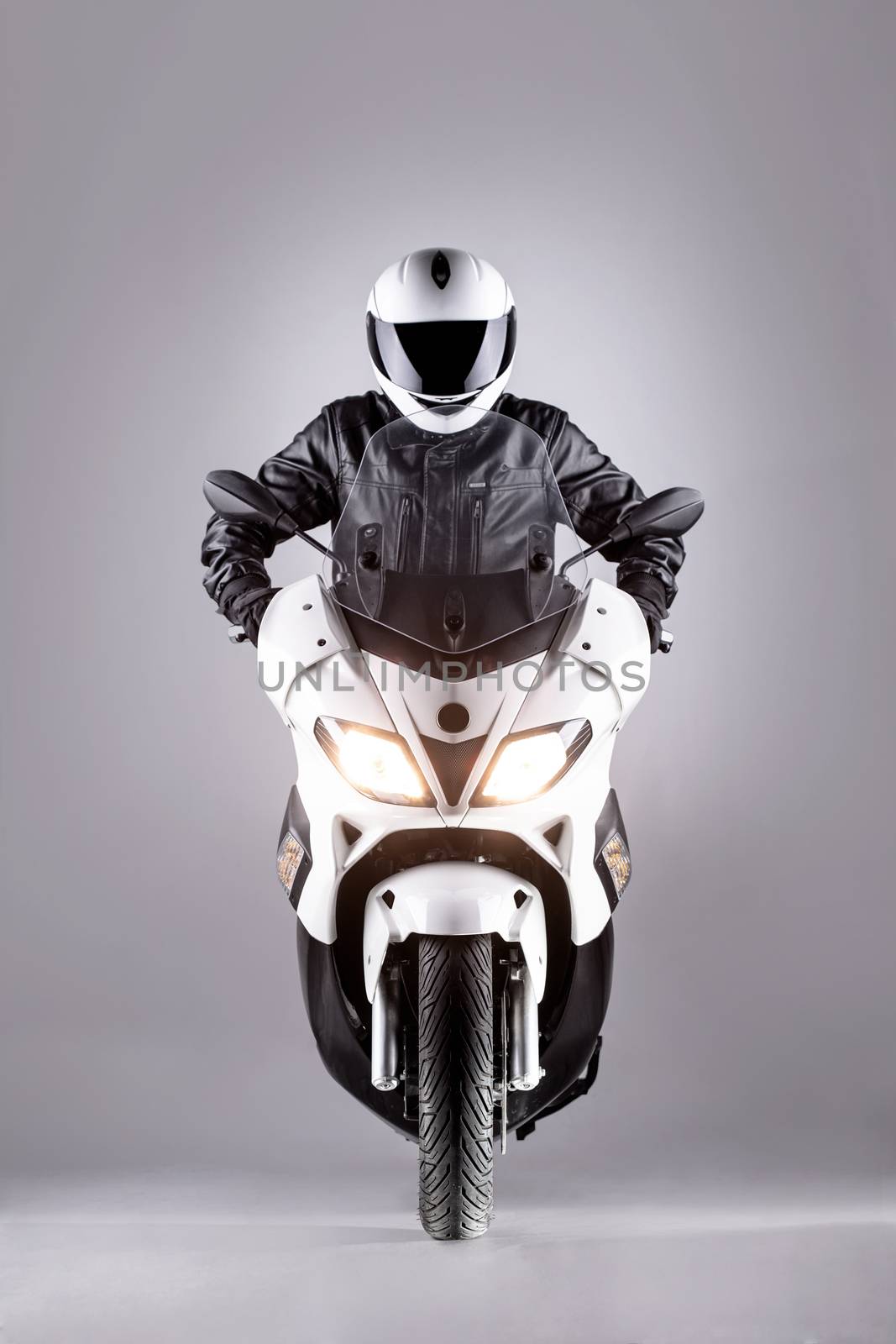 motorist on a motorcycle against gray background
