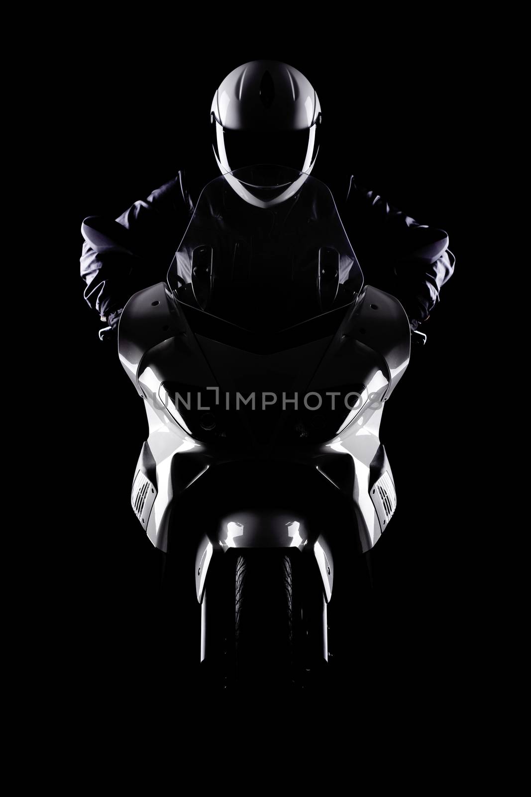 motorist on a motorcycle against black background