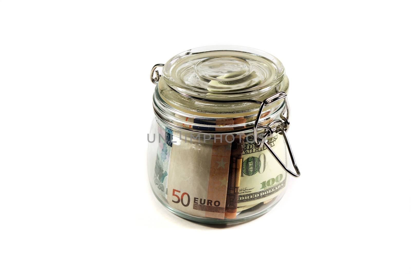 Glass jar filled with banknotes of different countries