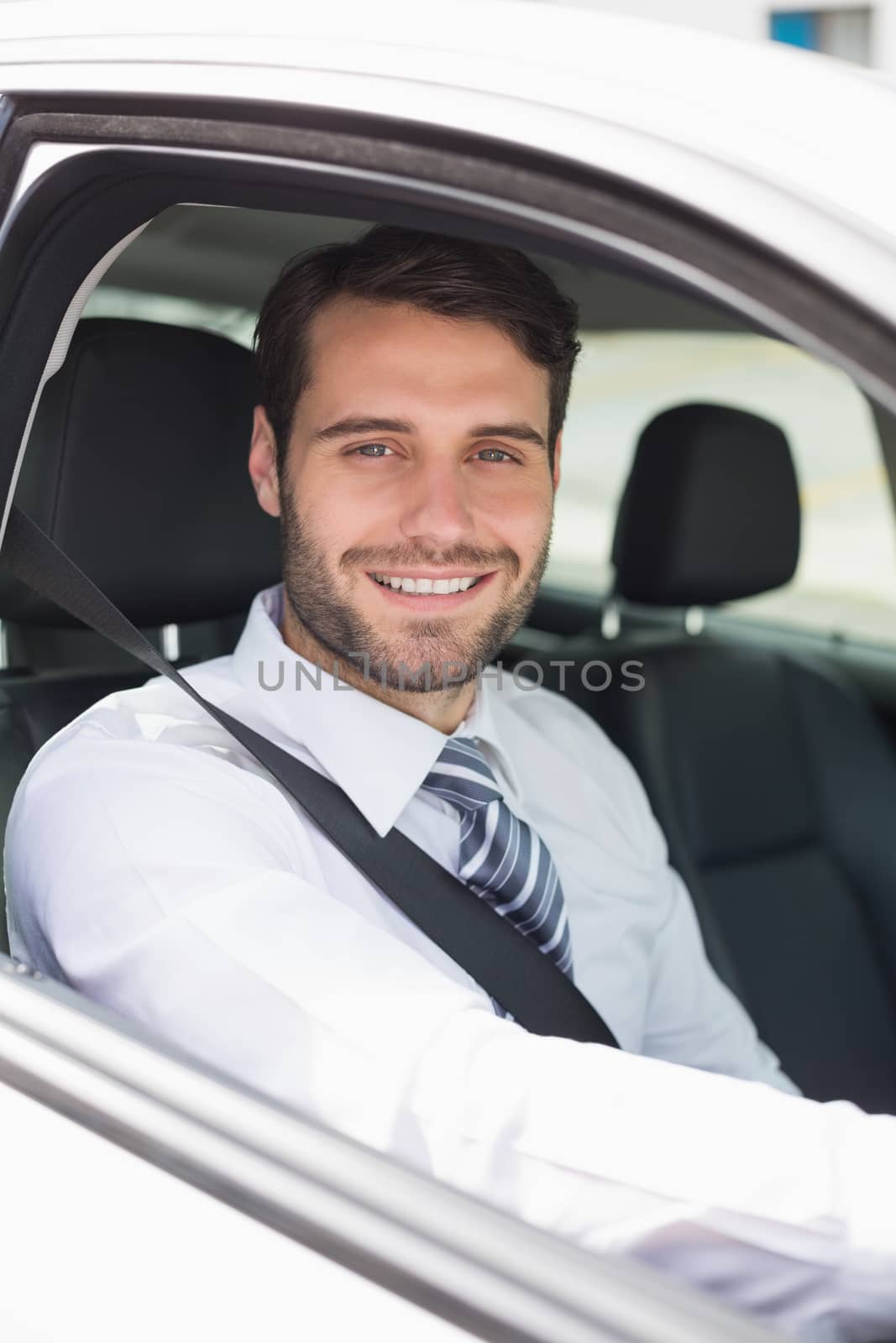 Businessman sitting in drivers seat in his car