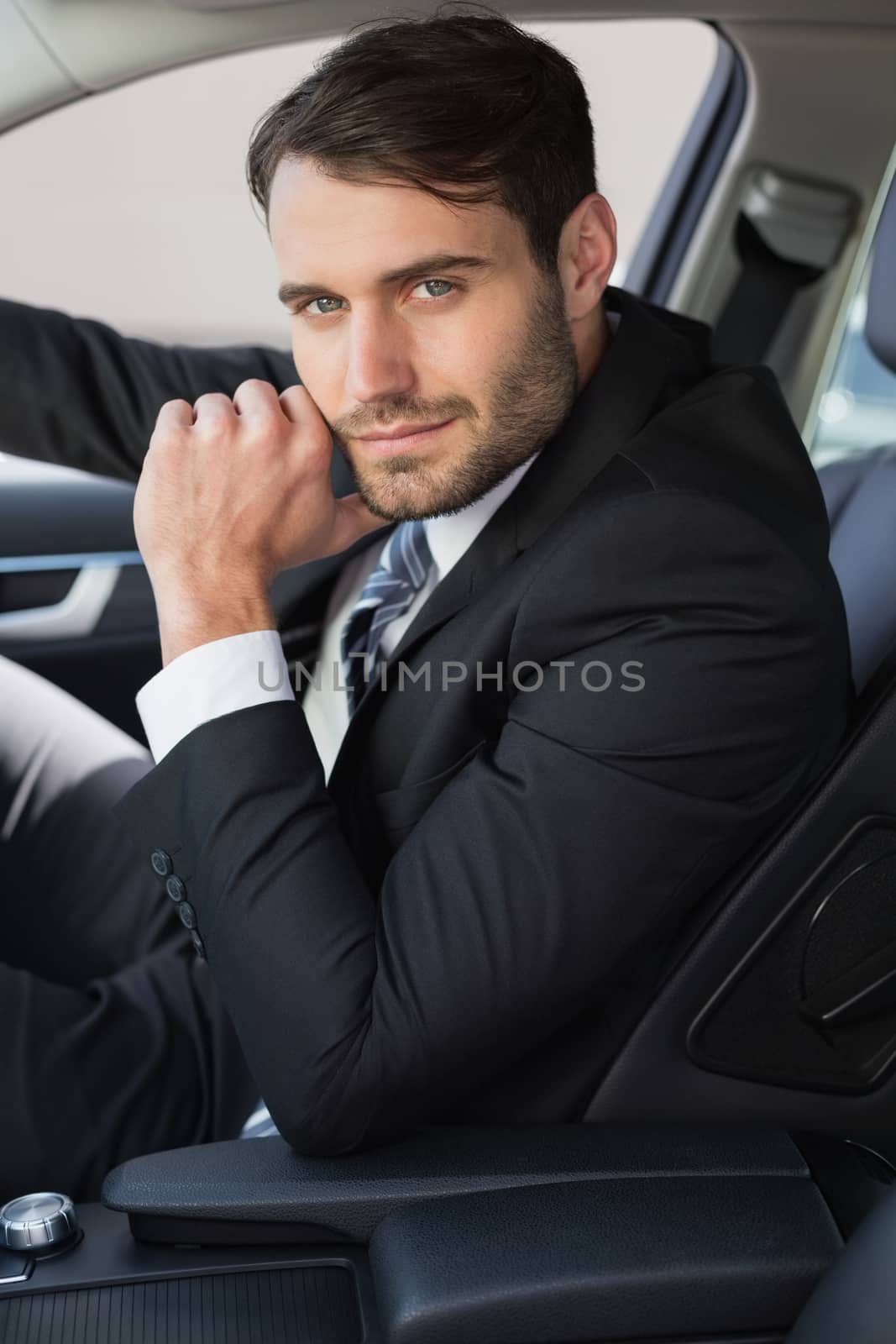 Businessman sitting in drivers seat in his car