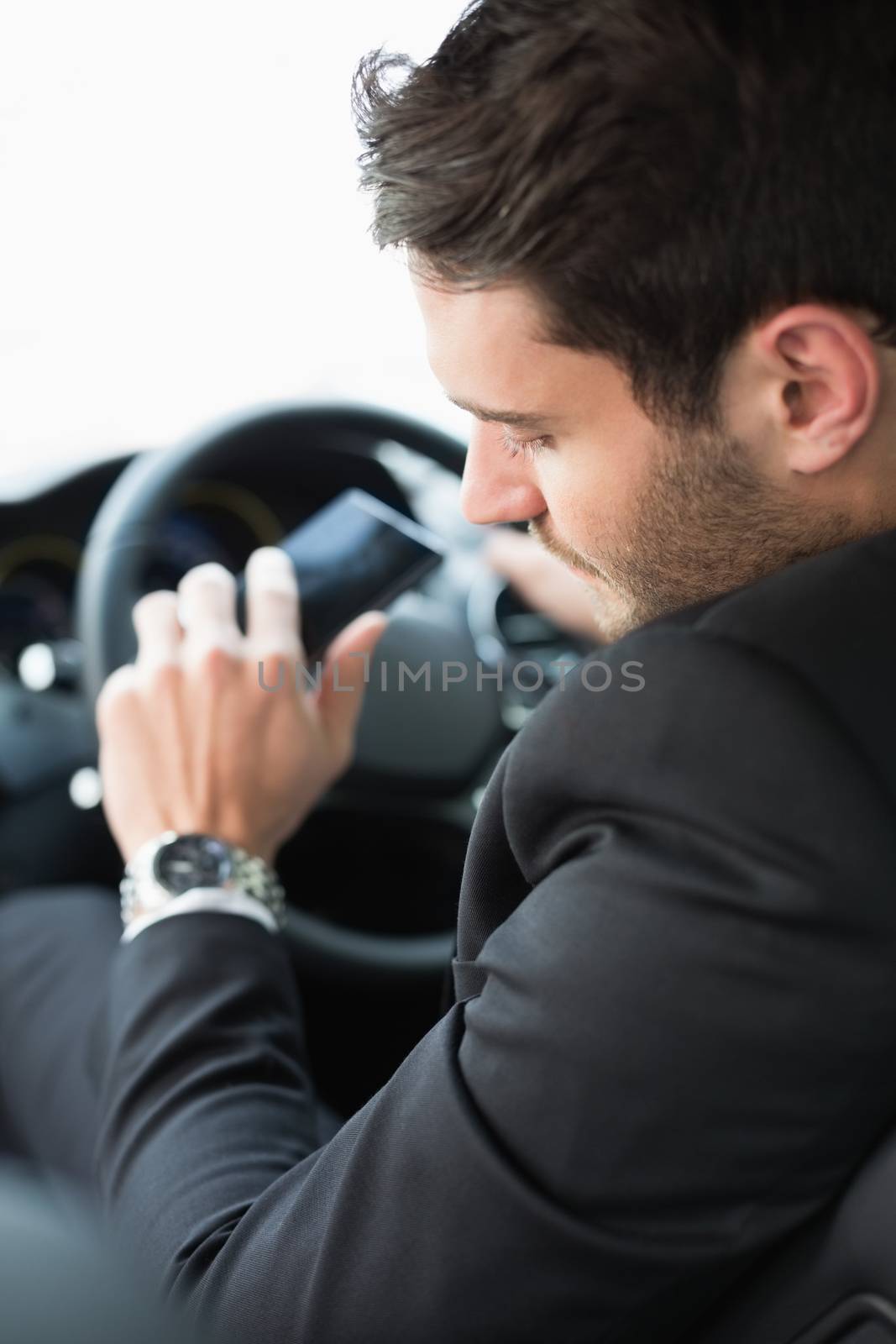 Young businessman checking his watch by Wavebreakmedia