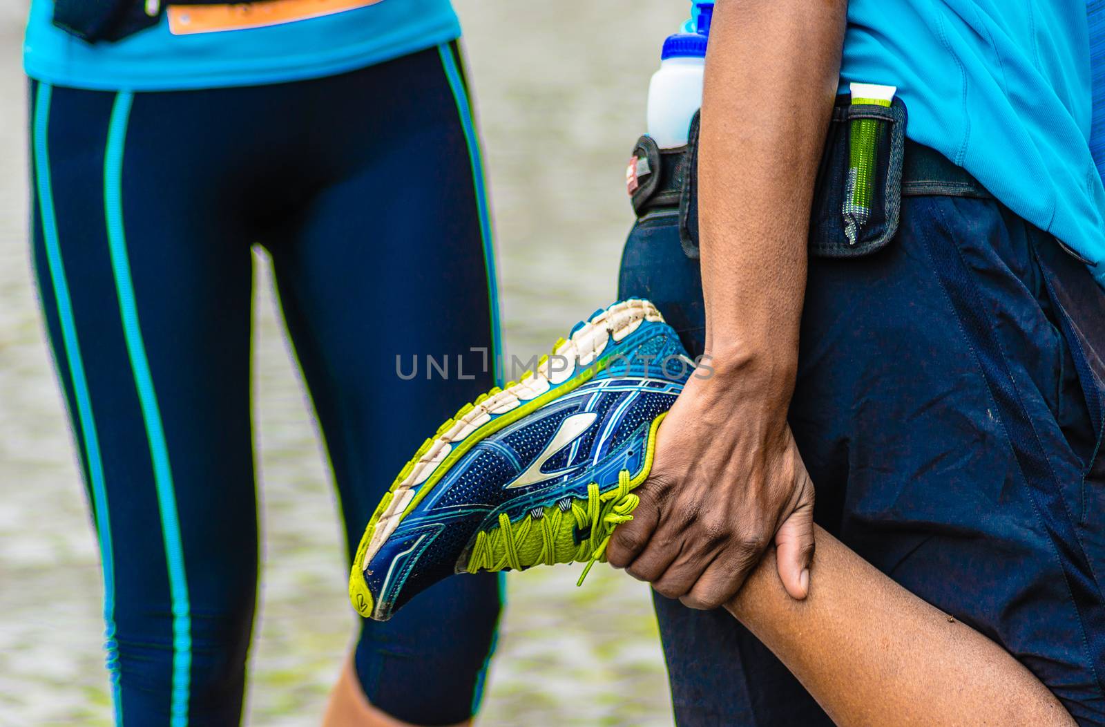 a runner caught stretching his right leg after a marathon