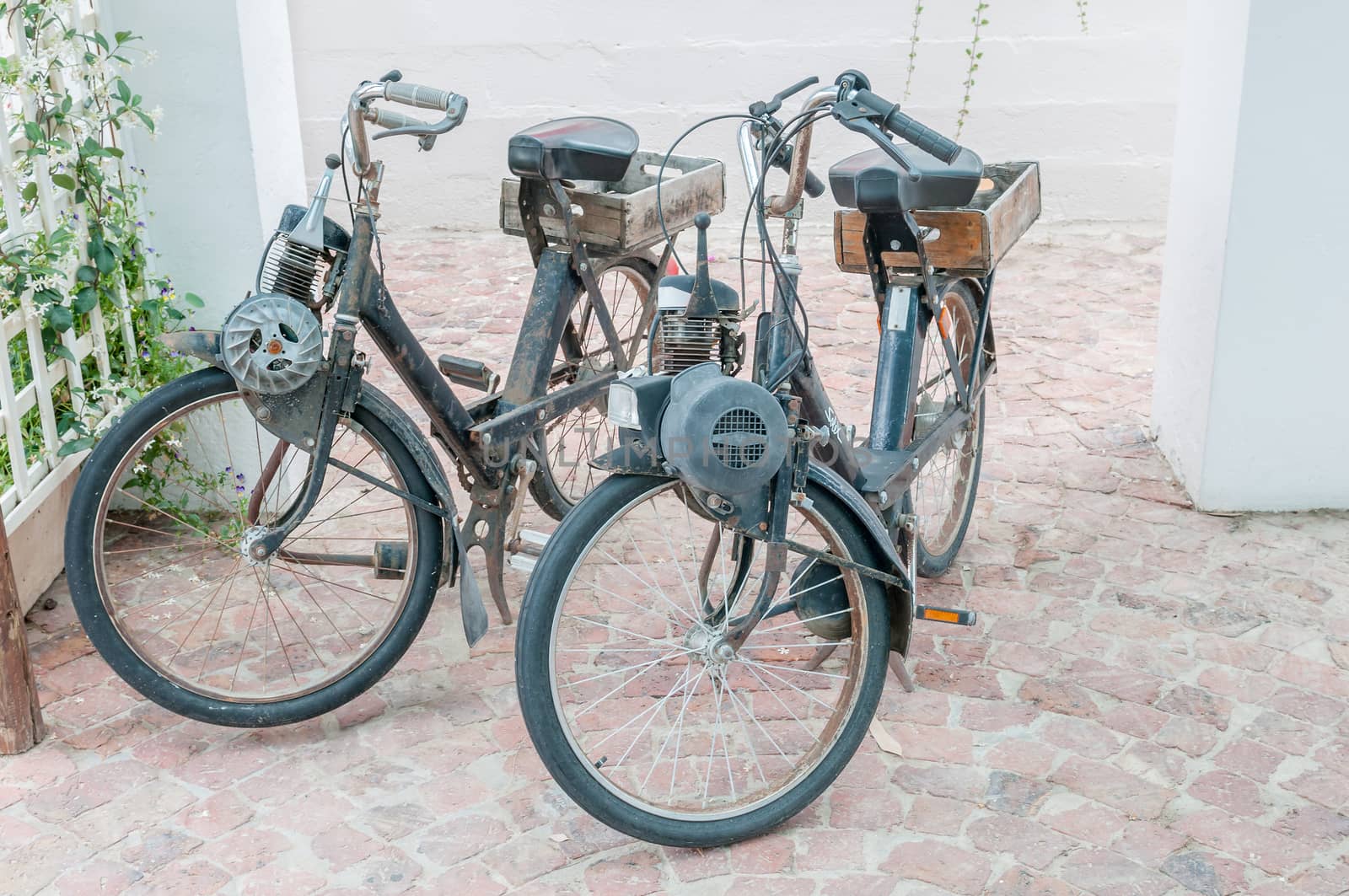 HEX RIVER, SOUTH AFRICA - DECEMBER 2, 2014: Two vintage motorised bicycles on display at a roadside stall in the Hex River Valley