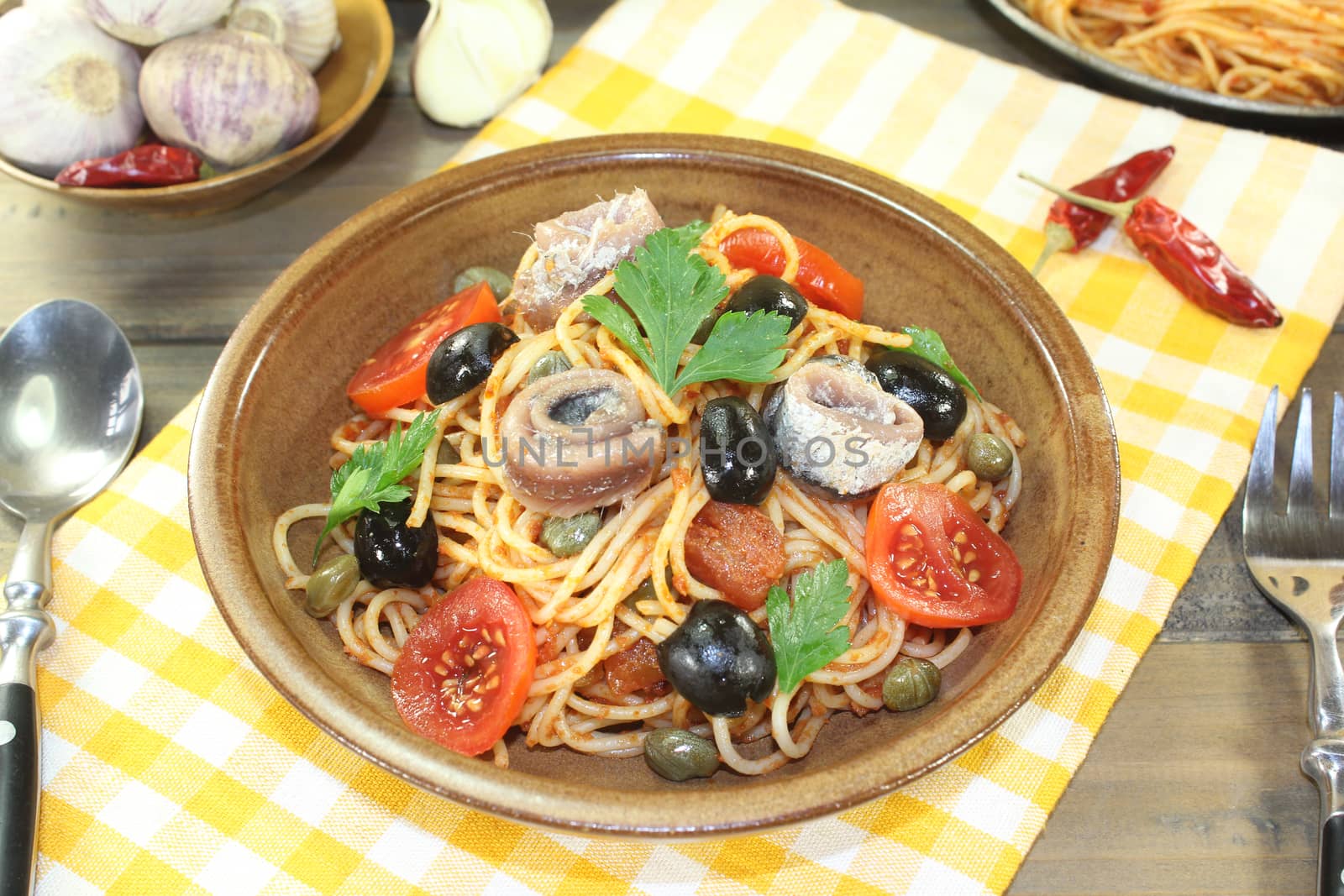 Spaghetti alla puttanesca with olives, capers and anchovies by discovery