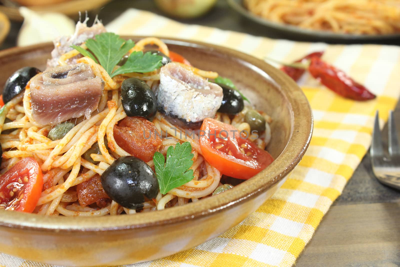 Spaghetti alla puttanesca with olives and tomatoes by discovery