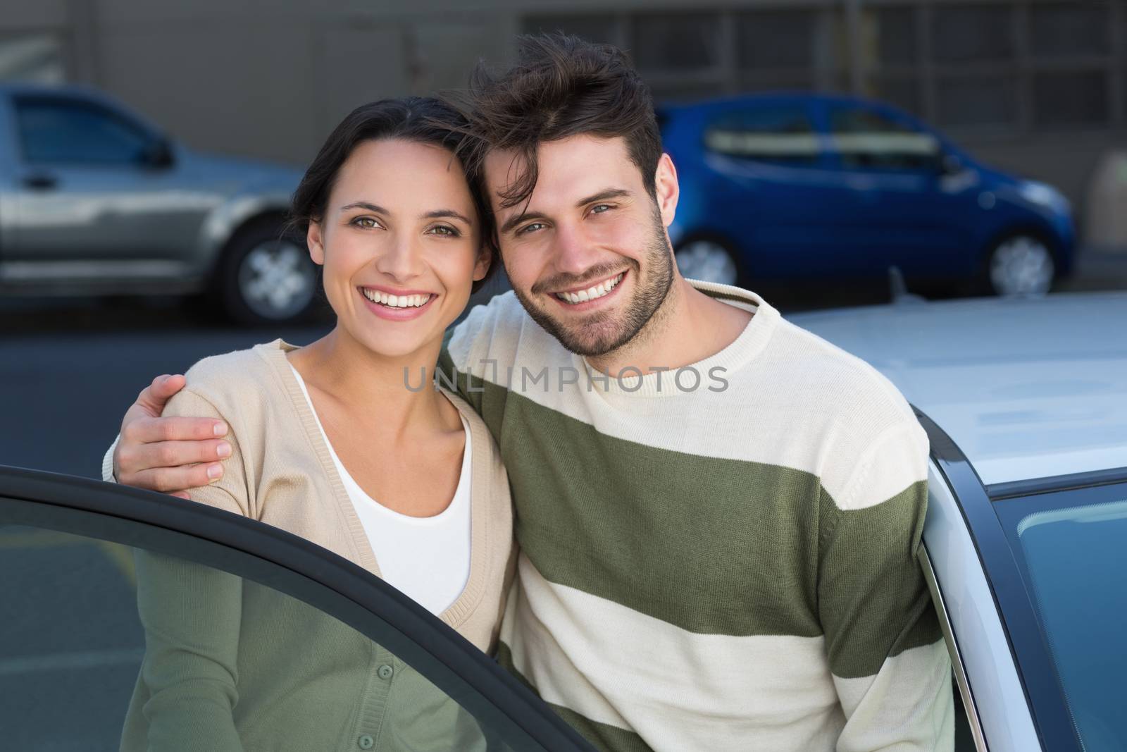 Young couple smiling at camera by Wavebreakmedia