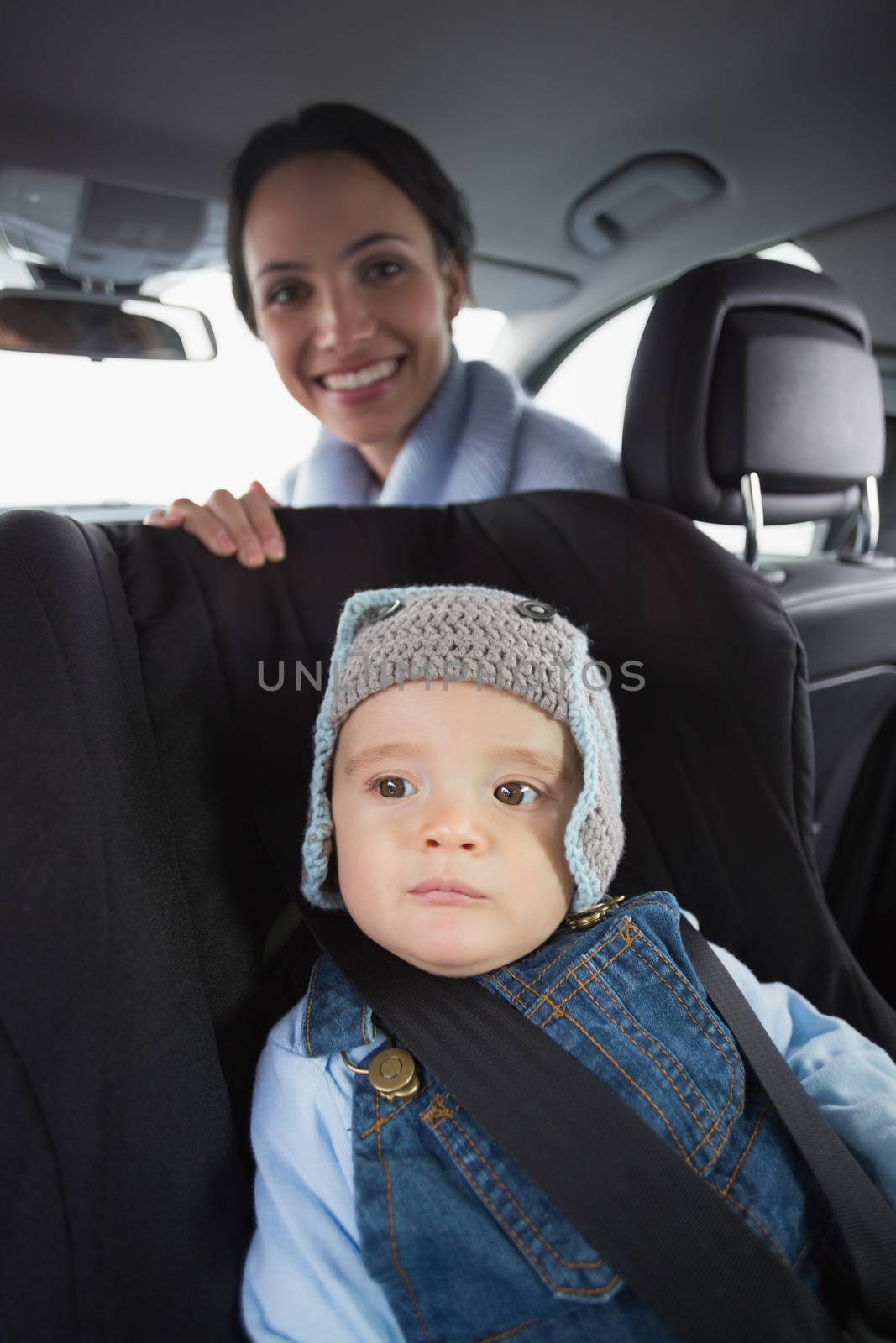 Mother checking her baby in the car seat by Wavebreakmedia