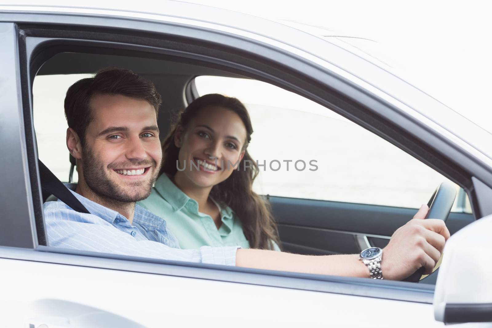 Young couple smiling at the camera by Wavebreakmedia