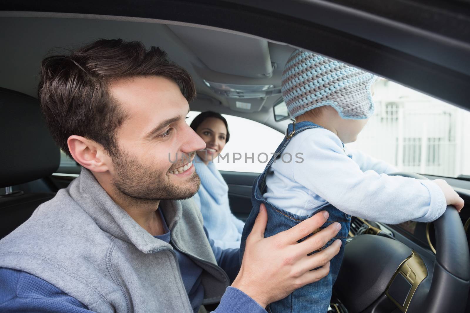 Parents and baby on a drive in their car