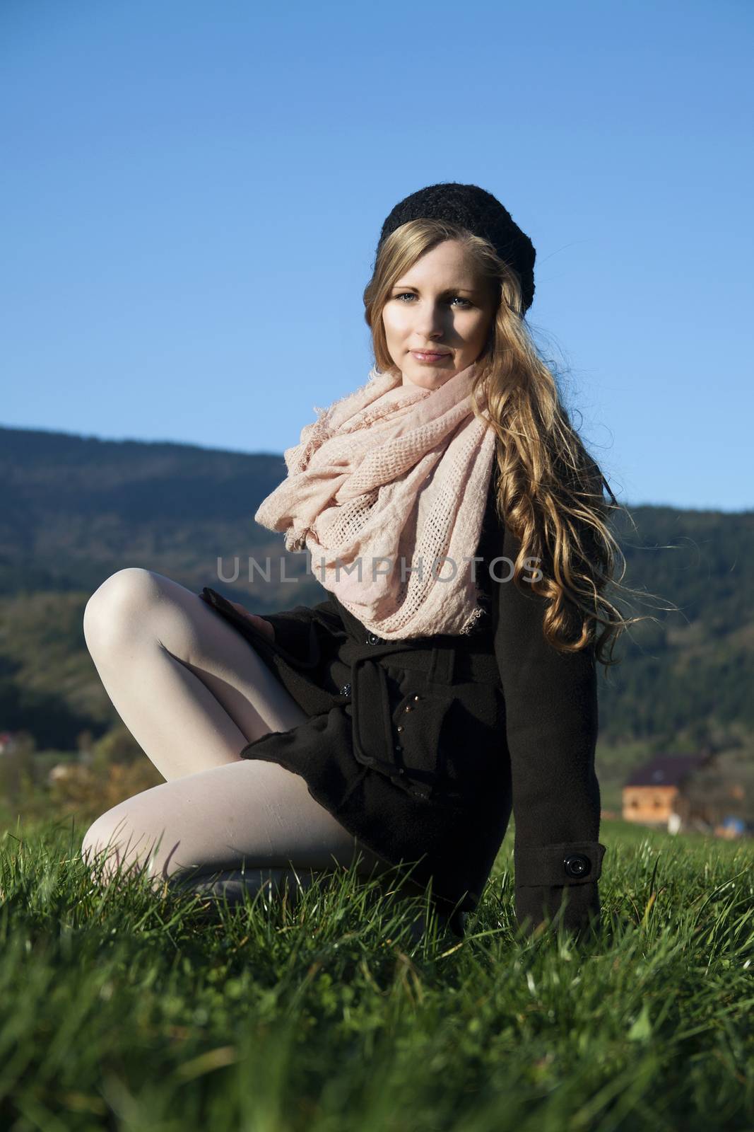 The young long-haired blond woman in French style, with beret and short coat