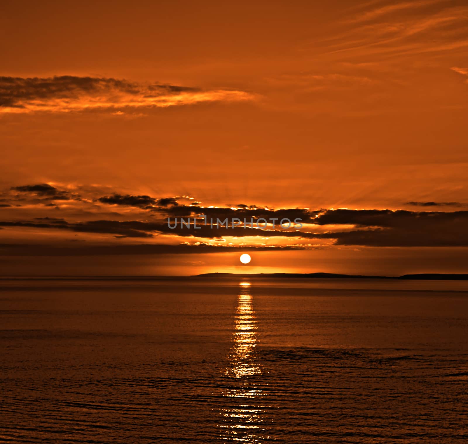 orange sunset over loop head in clare by morrbyte