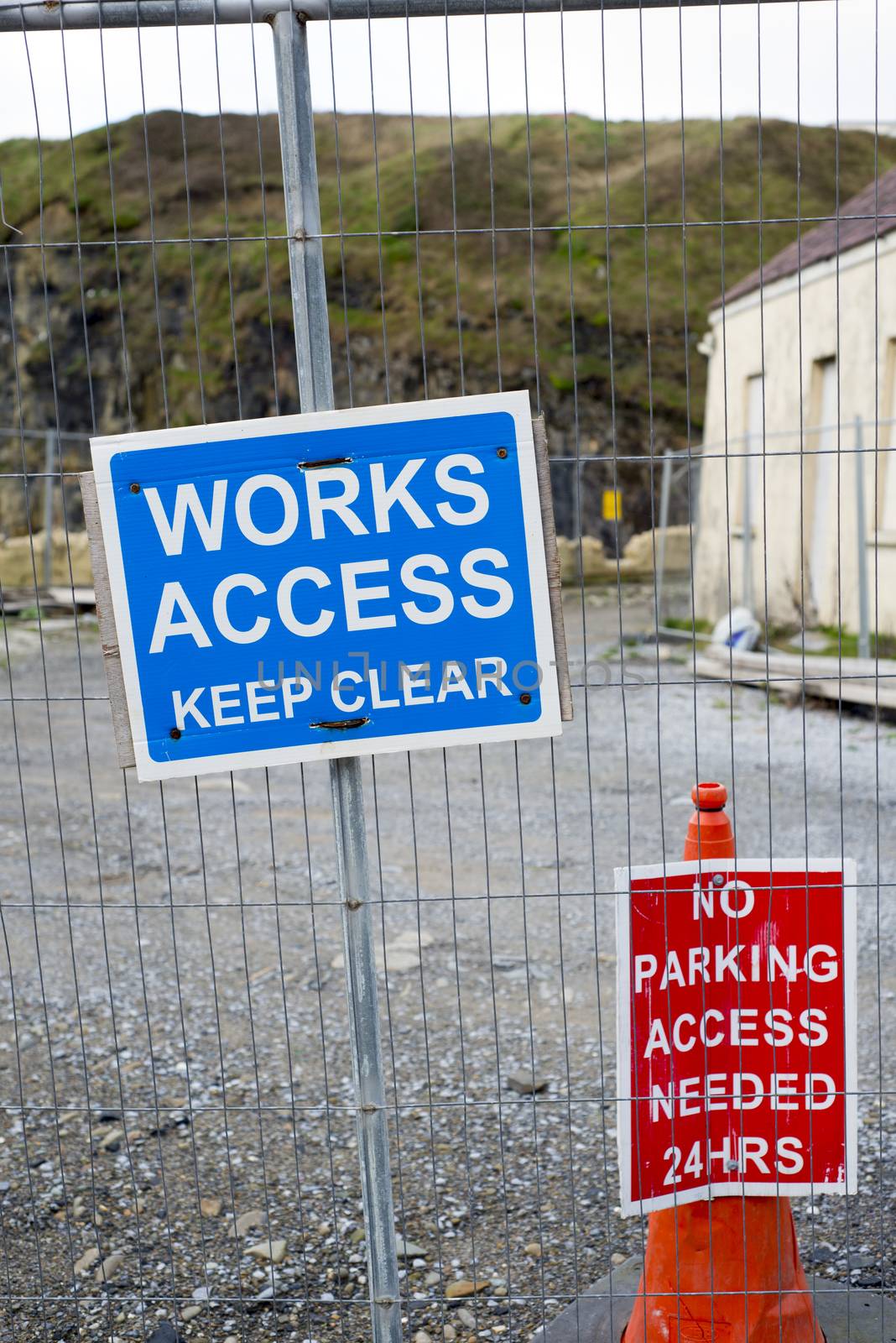 signs on the boundary fence of a building site by morrbyte