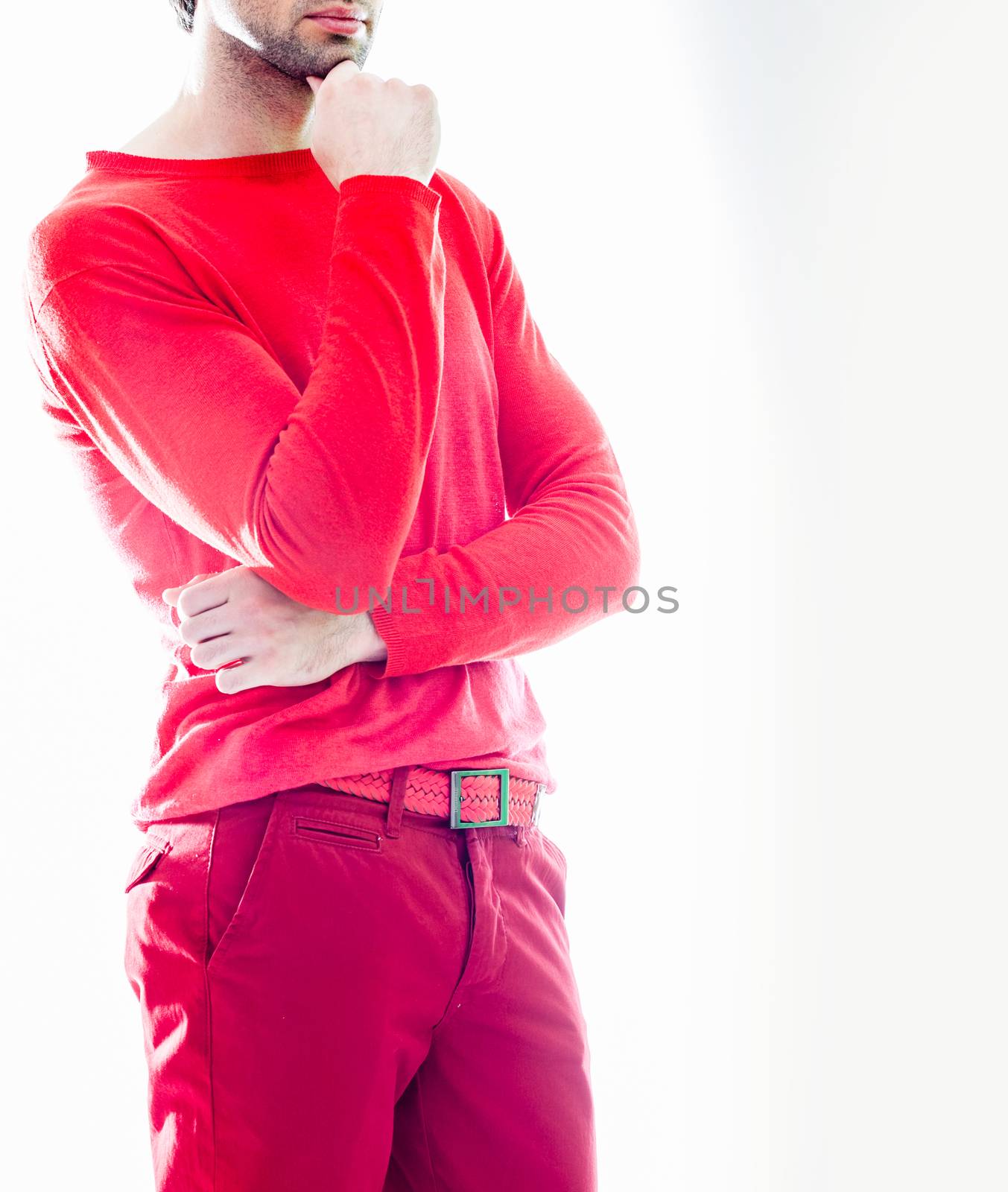 Elegant young handsome man in red clothing. Studio fashion portrait.