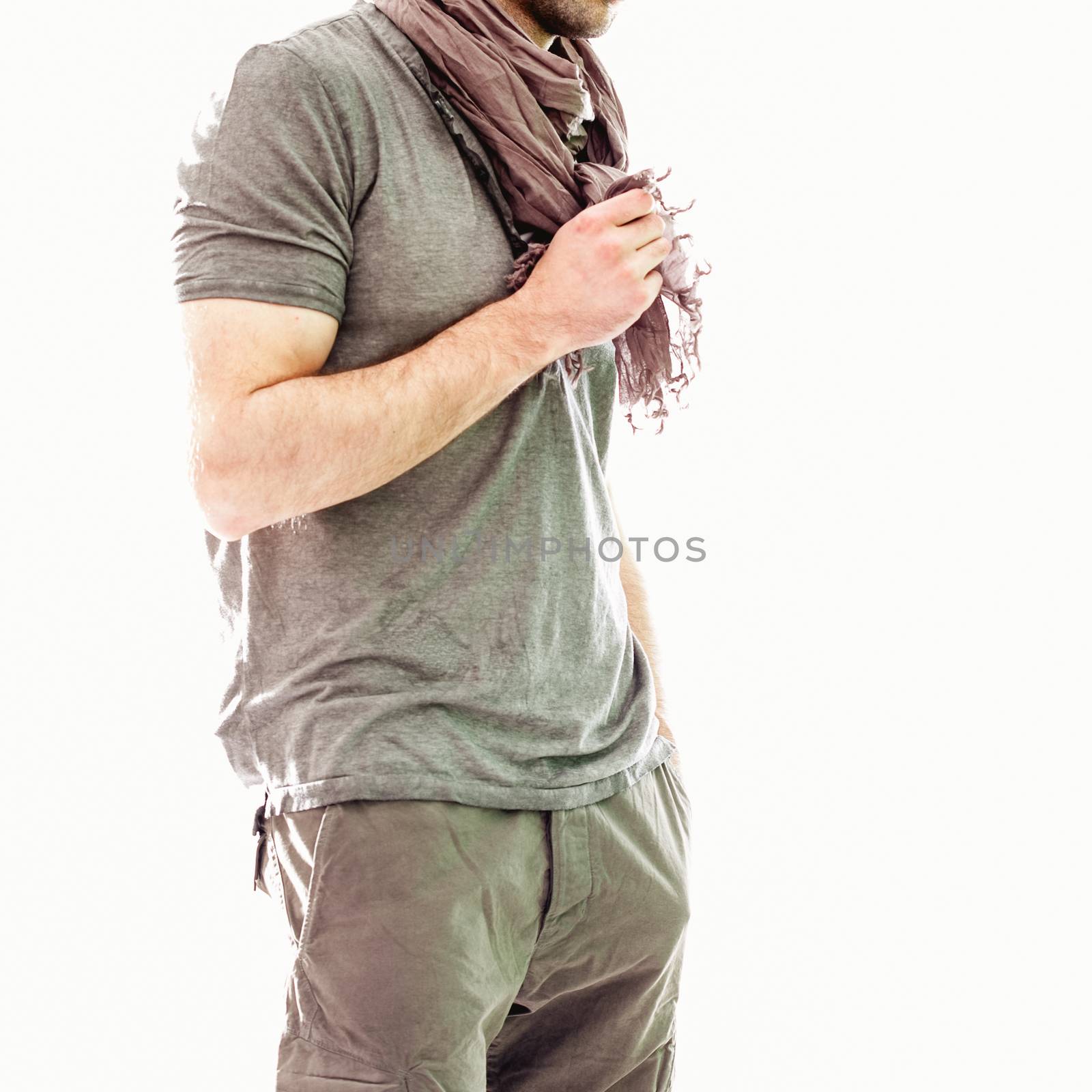 Elegant young handsome man in gray clothing. Studio fashion portrait.