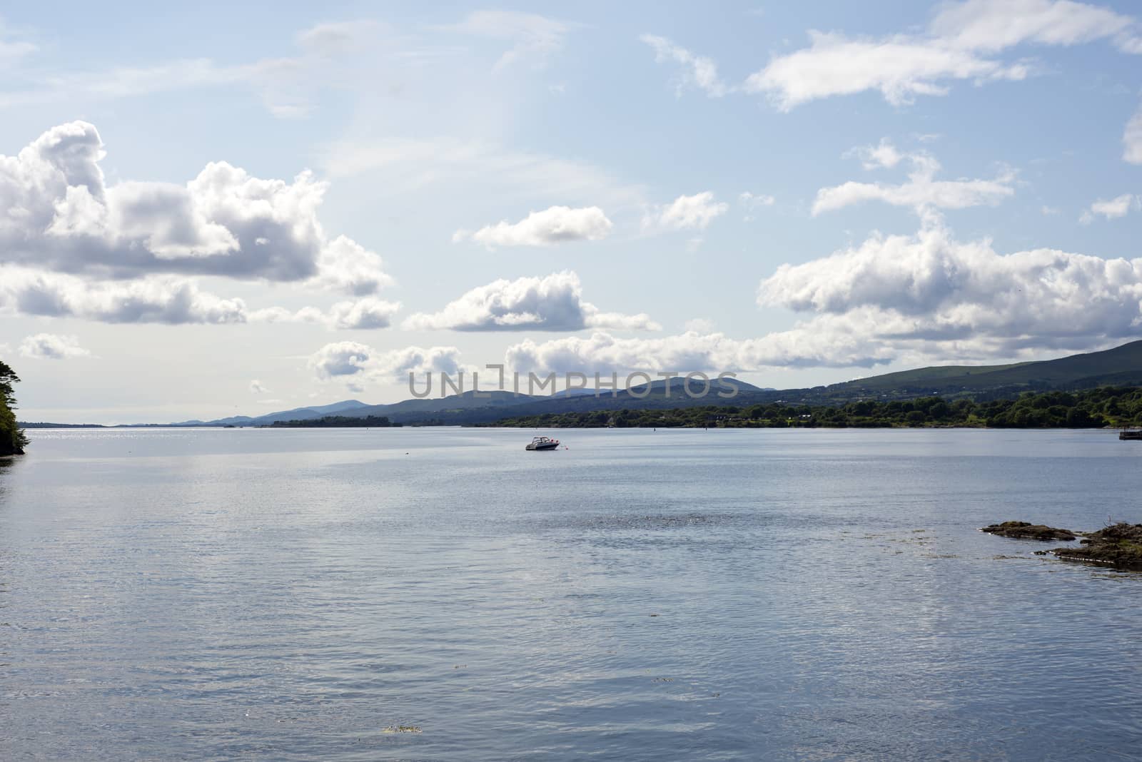 single boat in a quiet bay by morrbyte